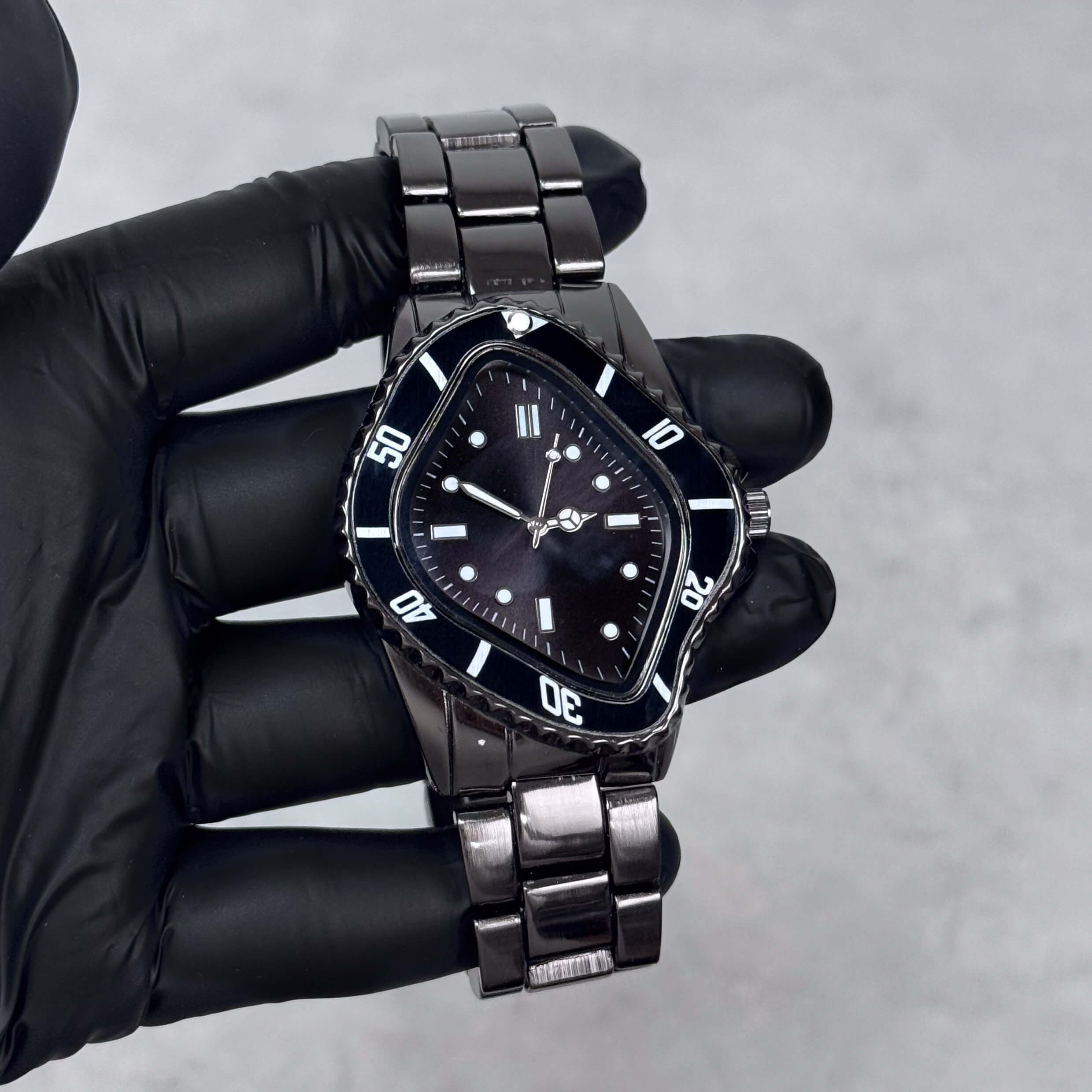 Black Men’s 42mm warped case watch with black dial, polished metal band, and quartz movement.