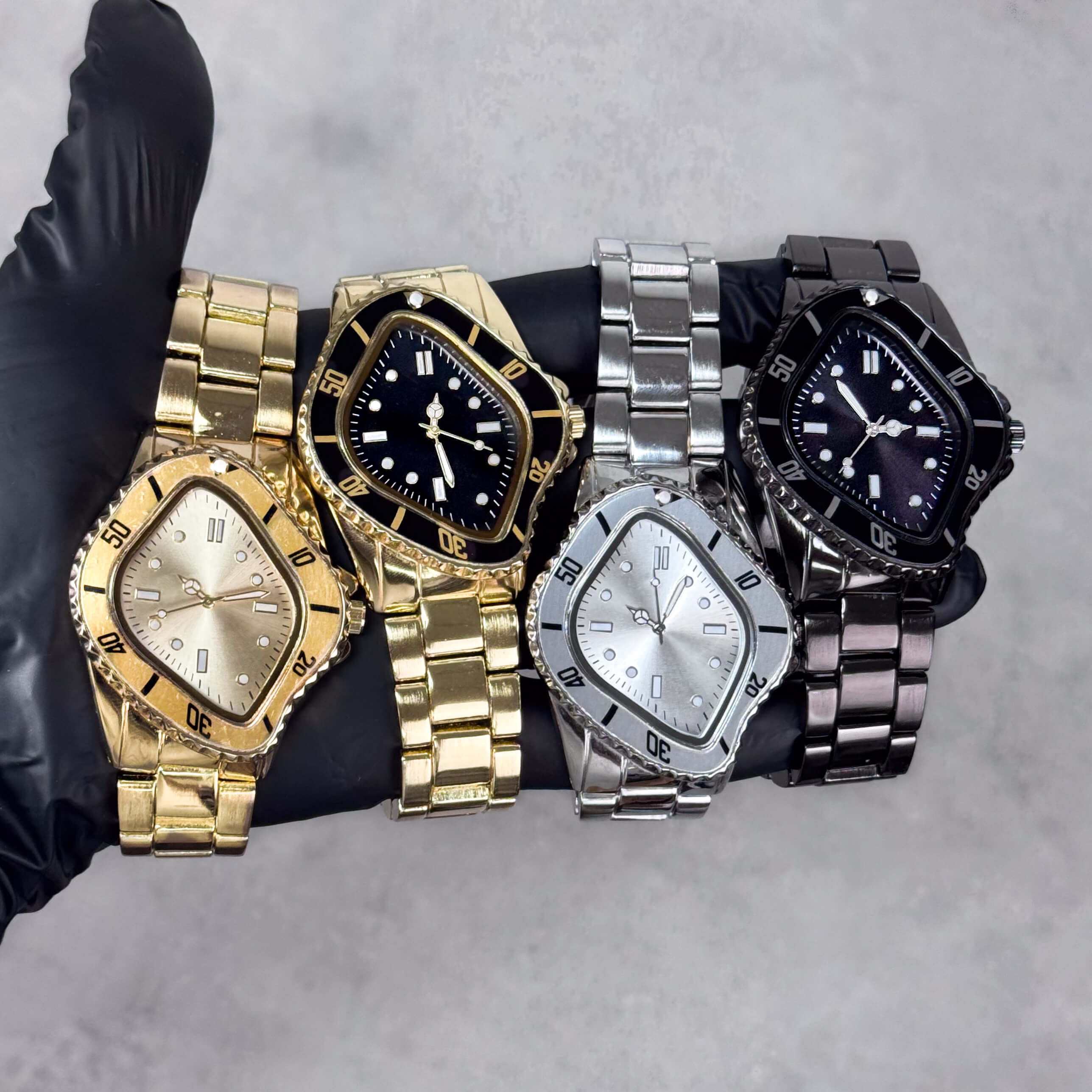 Men’s Classic 42mm Warped Case Watches in gold, silver, and black with metal bands shown together.