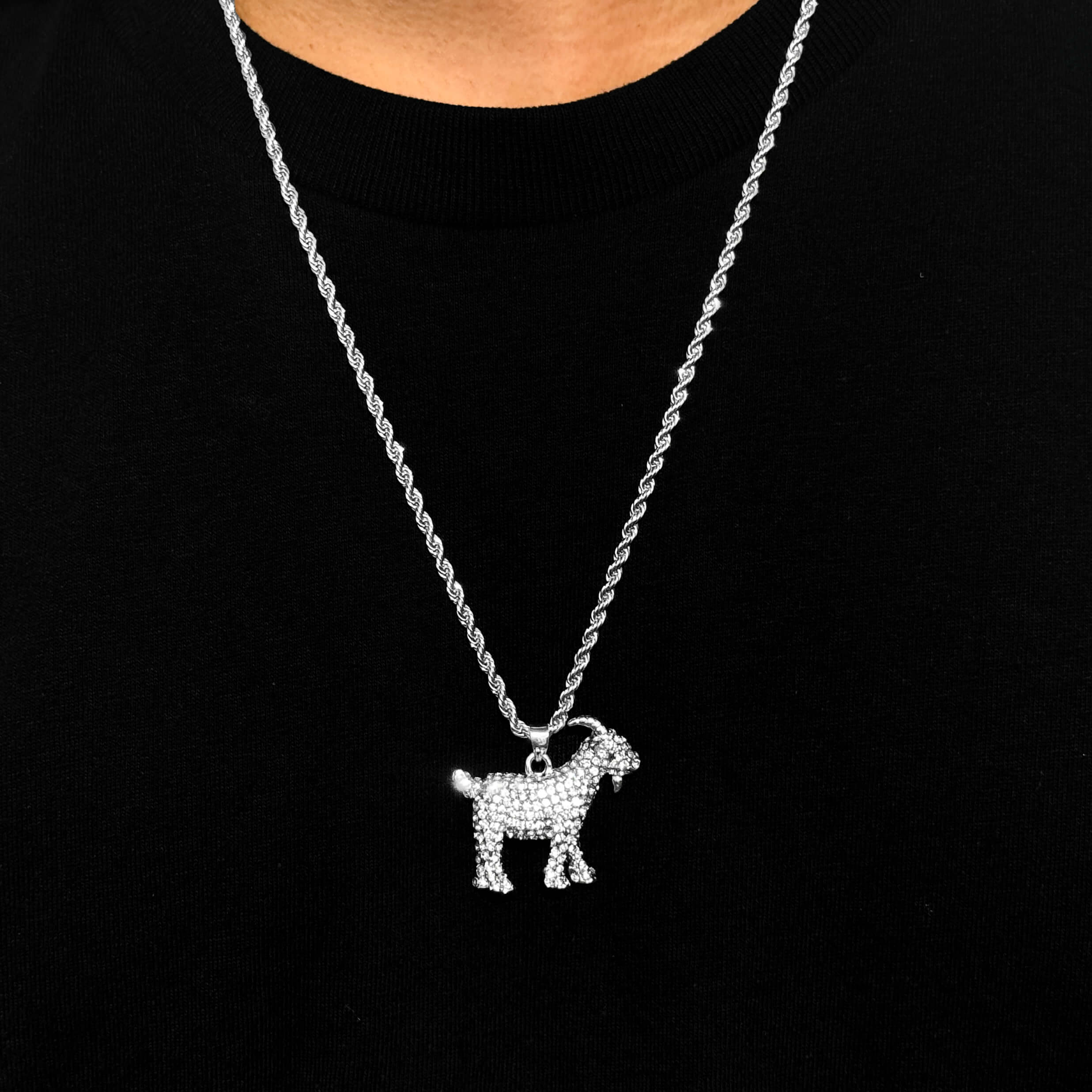 Silver iced out GOAT pendant on 4mm rope necklace, shimmering animal charm for streetwear style.