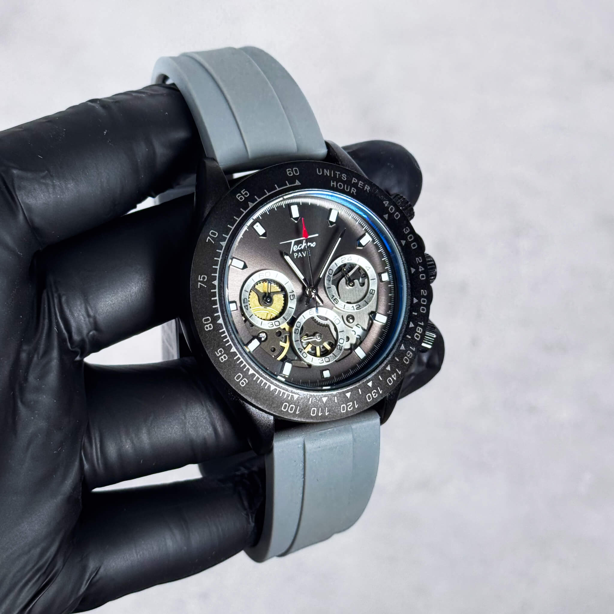 Men’s 42mm gray silicone band chronograph-style watch featuring multi-dial gray face and black bezel.