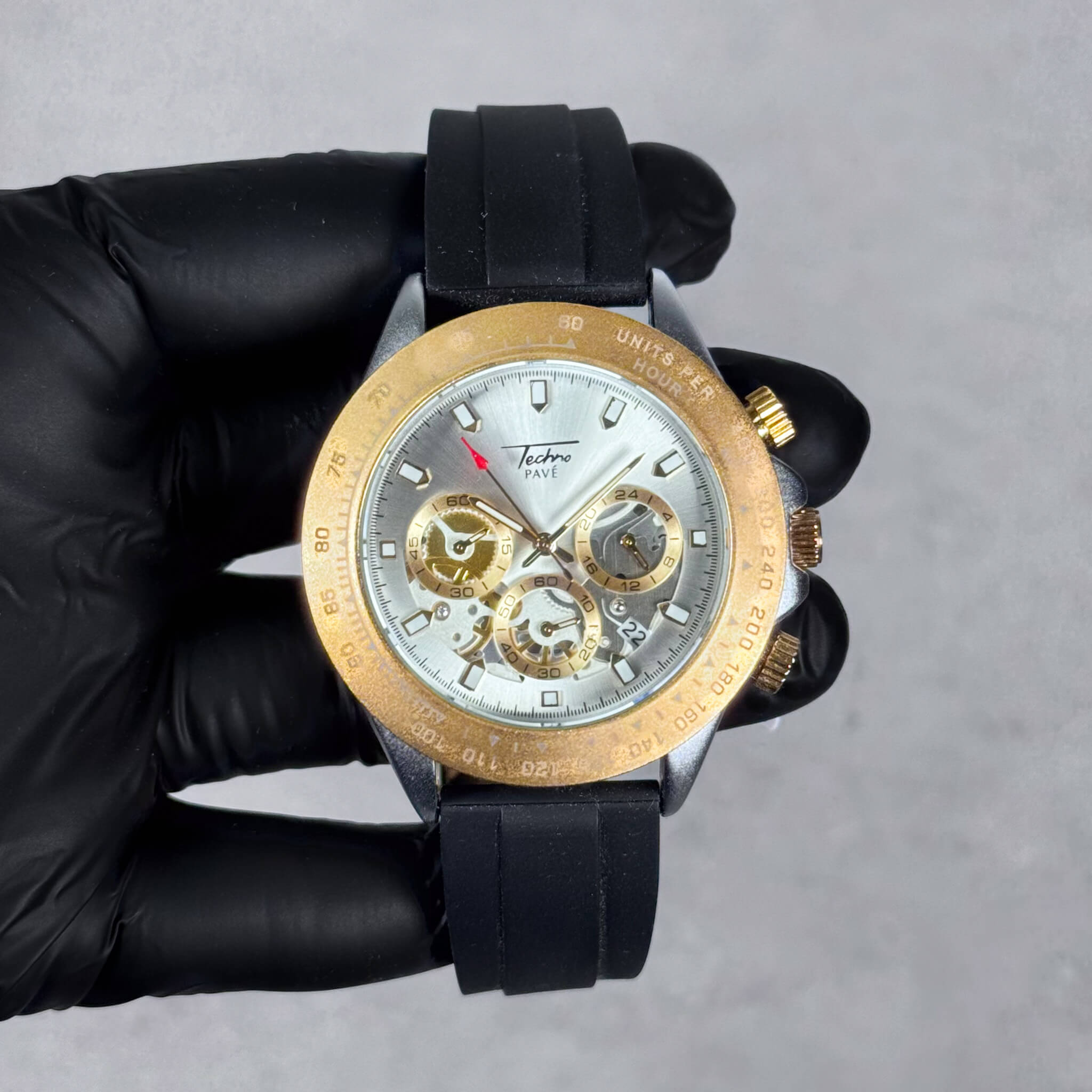 Gold and silver Men’s 42mm silicone chronograph watch with white multi-dial quartz face.