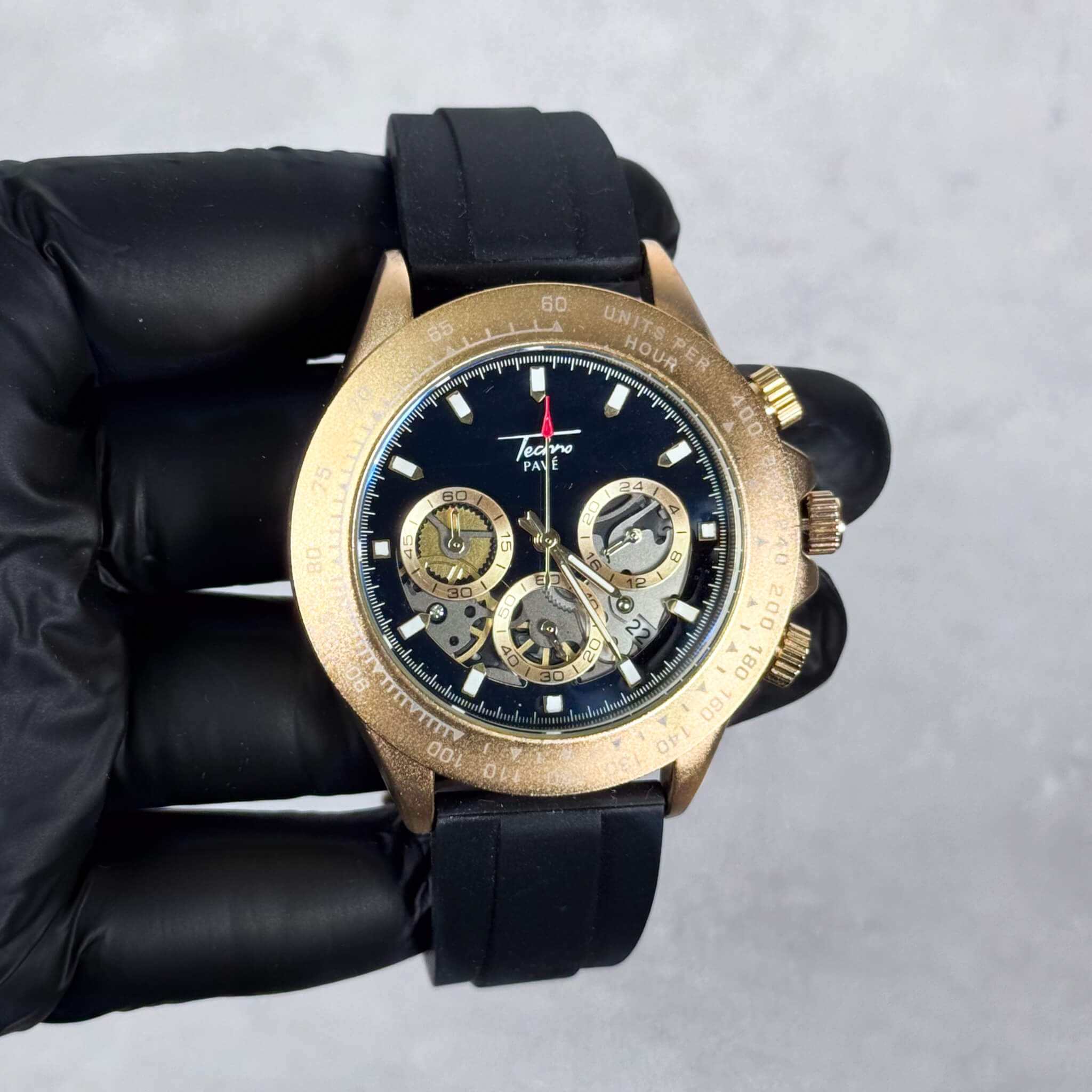 Gold Men’s 42mm silicone band chronograph watch featuring a black multi-dial quartz face.