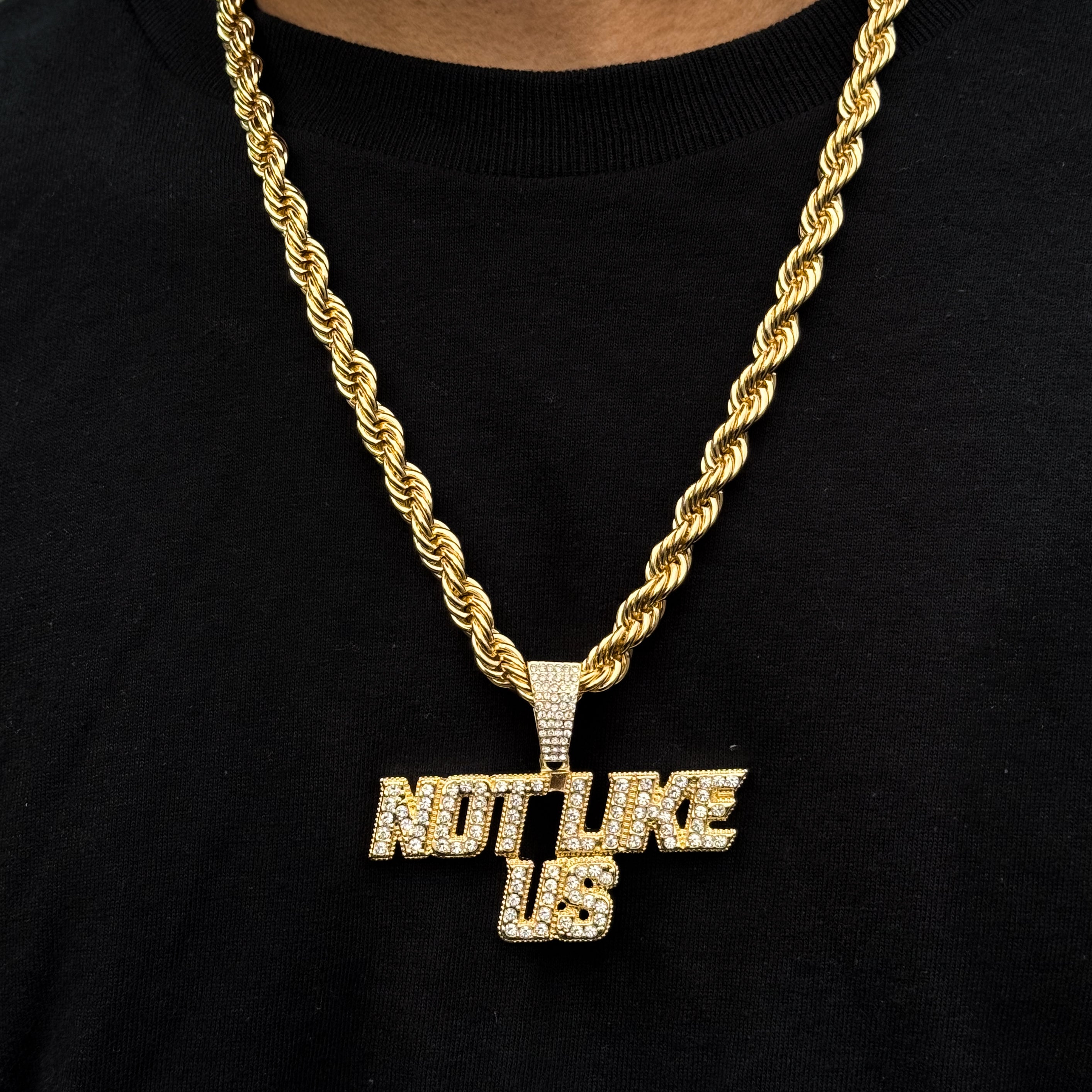 Men’s gold Not Like Us pendant necklace with iced-out lettering on 8mm rope chain