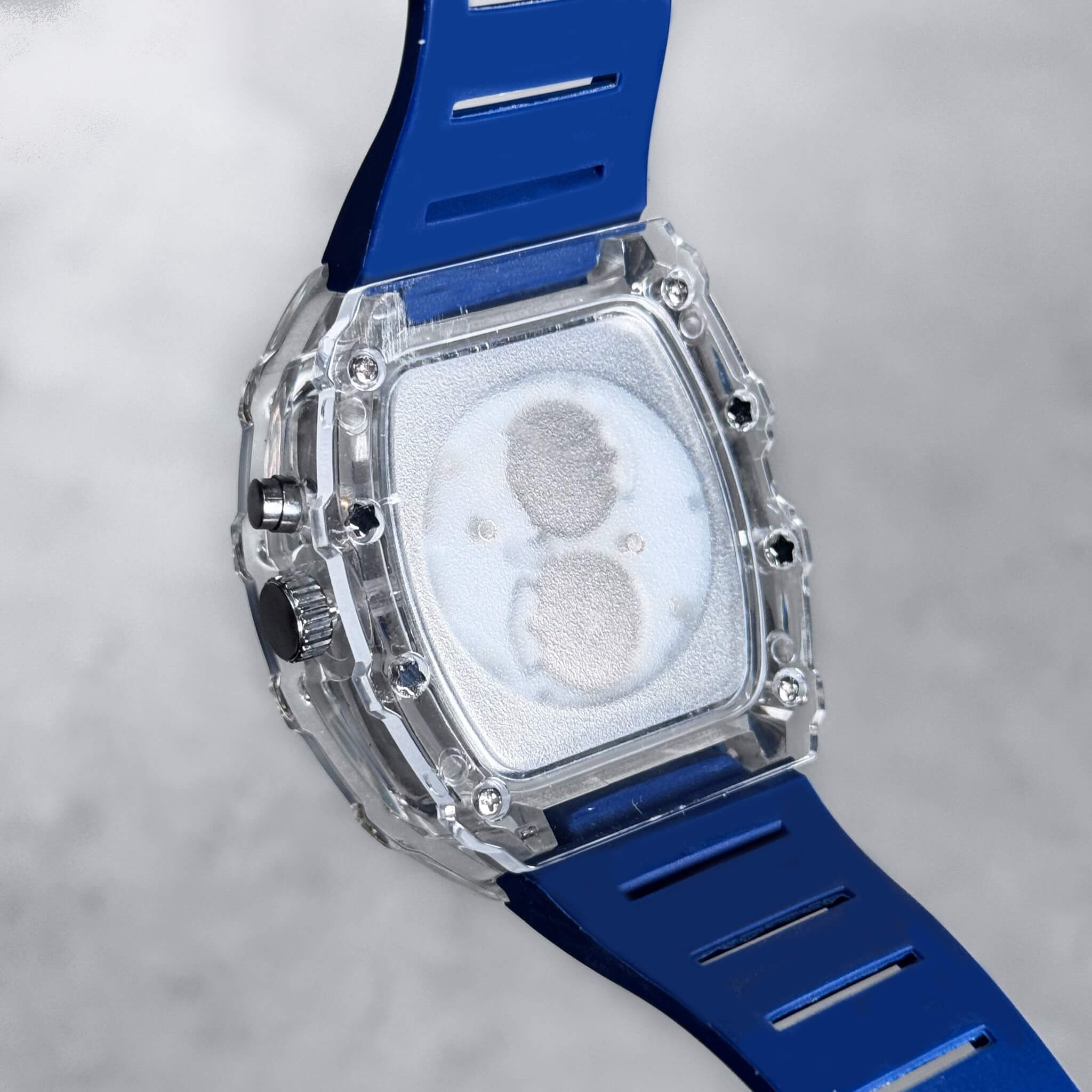 Men's 44mm Tonneau Dial Watch back view with transparent case and blue breathable silicone strap.