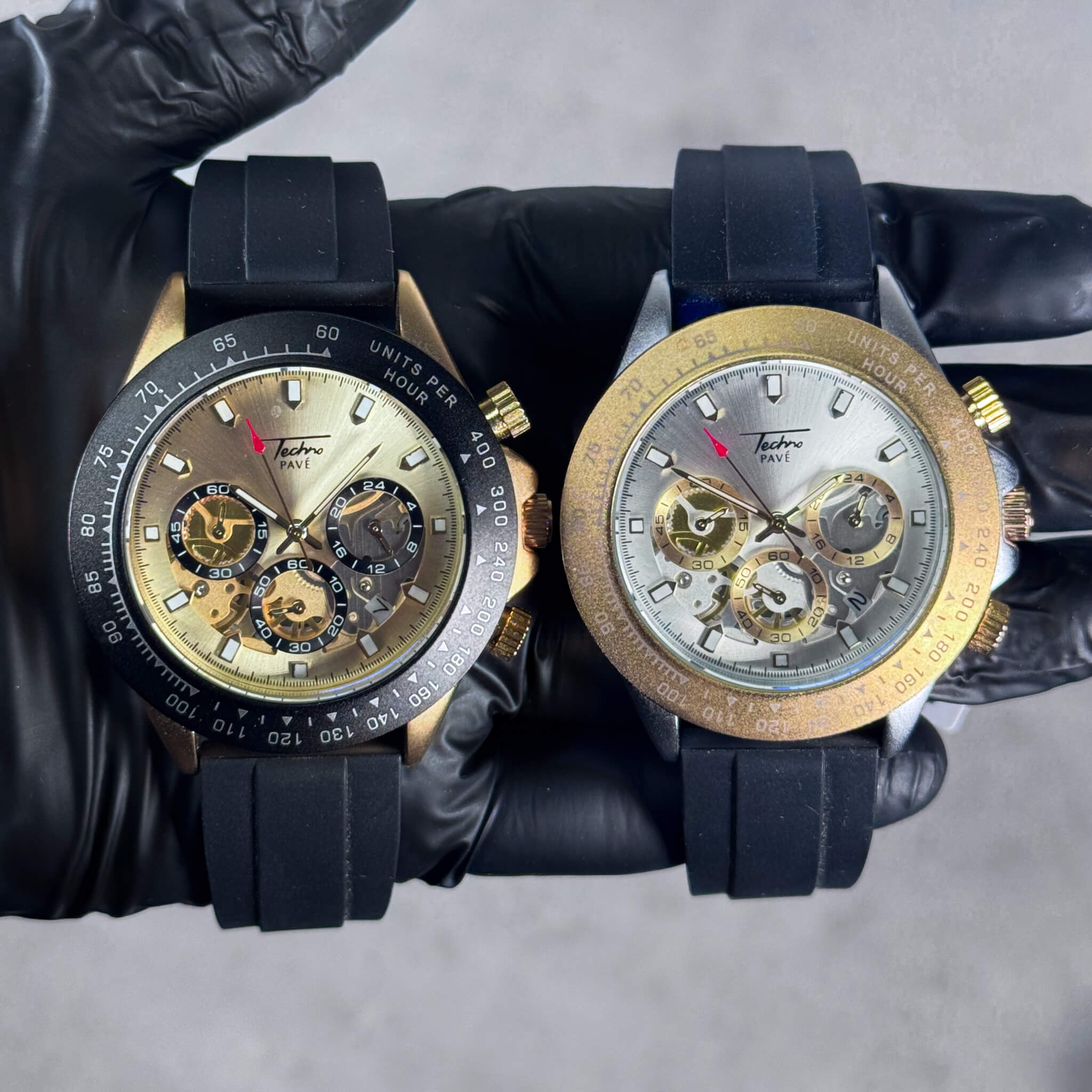 Gold and silver Men’s 42mm silicone chronograph watches with multi-dial quartz faces.