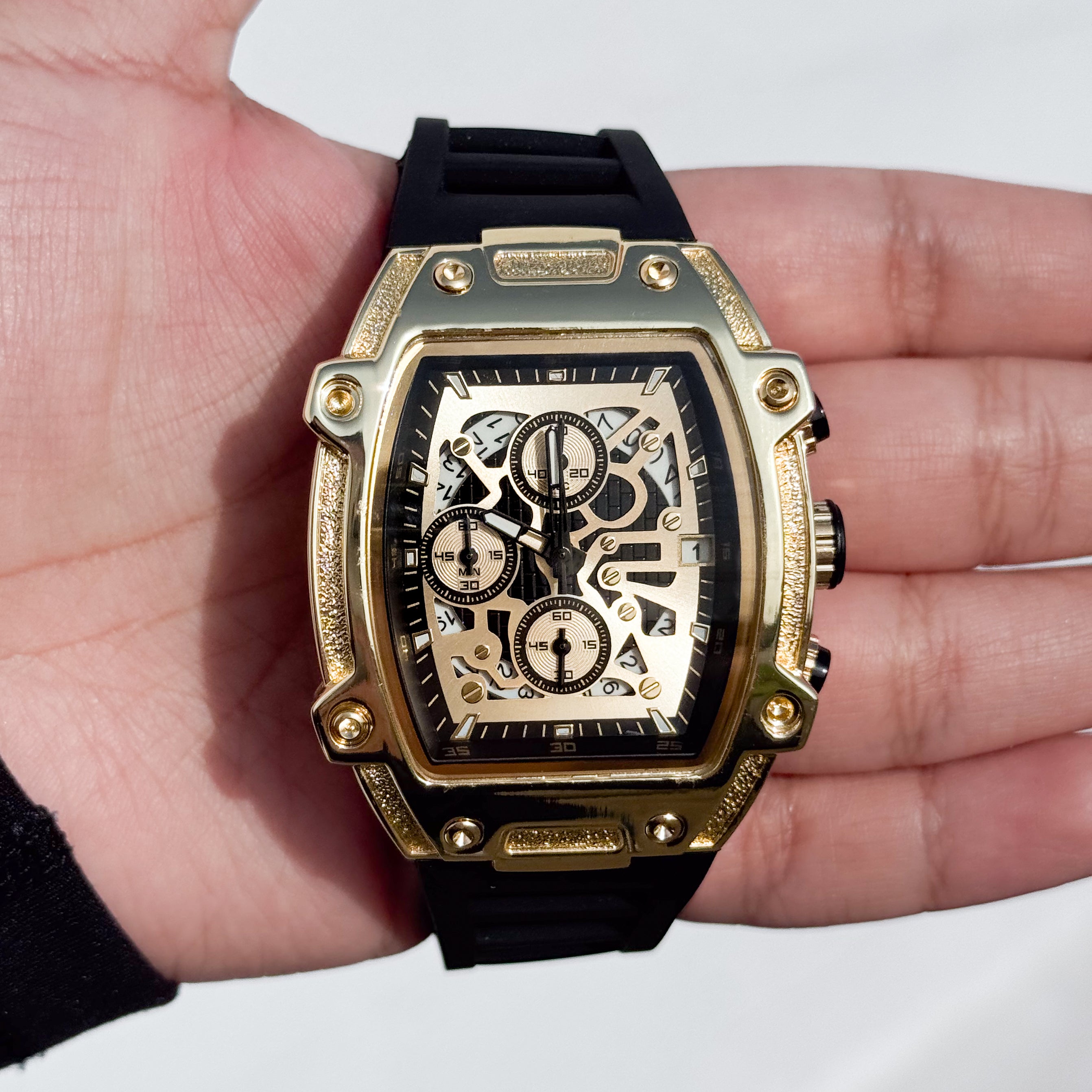 Gold Men's 41mm silicone band watch featuring a tonneau case, skeleton dial, and quartz movement.