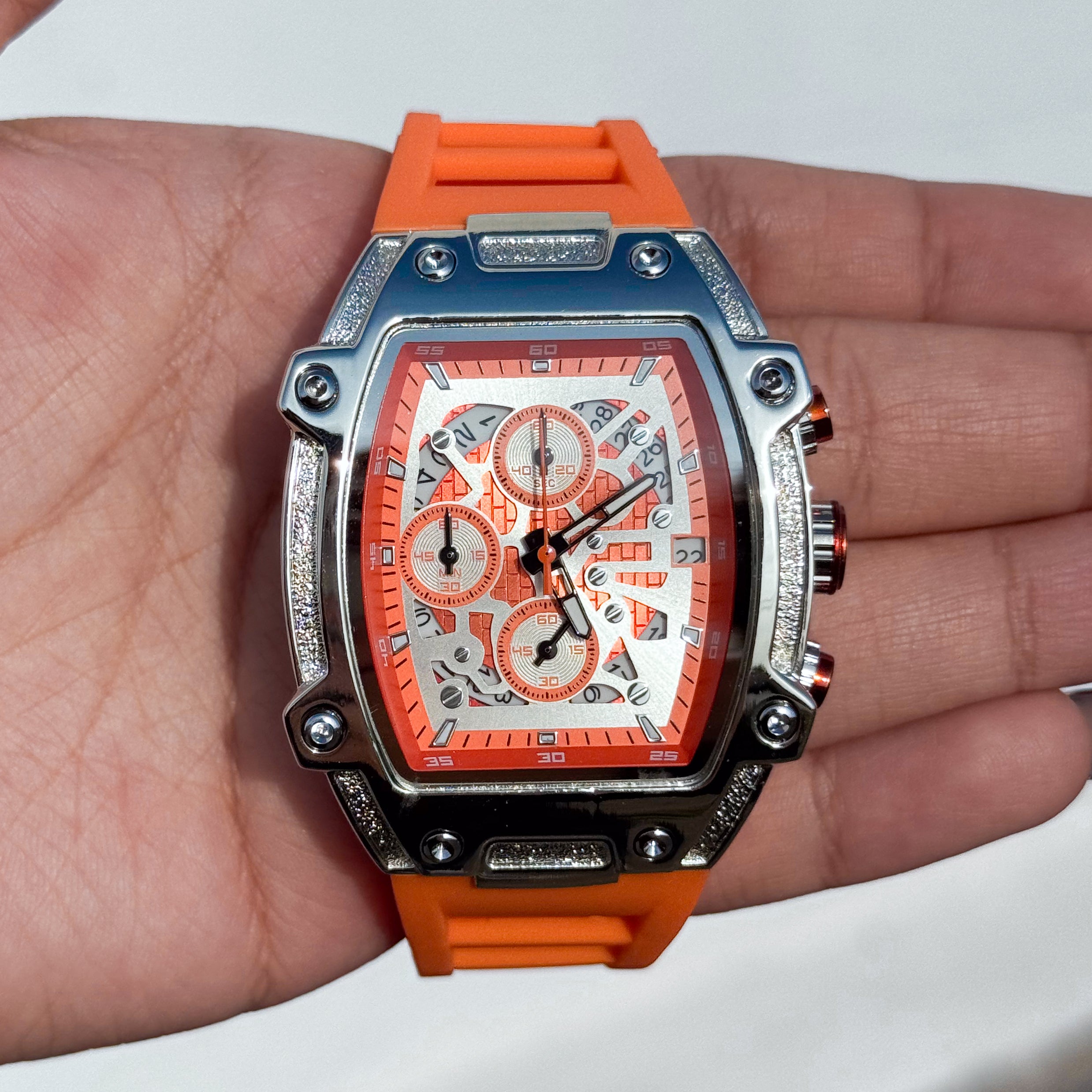 Orange Men's 41mm silicone band watch featuring a silver tonneau case and bold skeleton dial design.