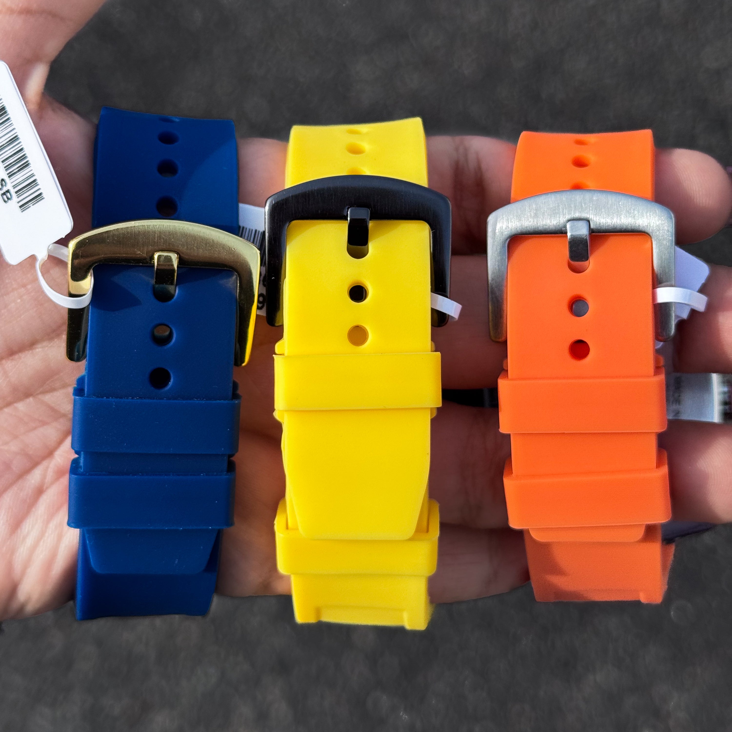 Blue, yellow, and orange silicone watch bands with metal buckles for Men’s 41mm sporty watches.