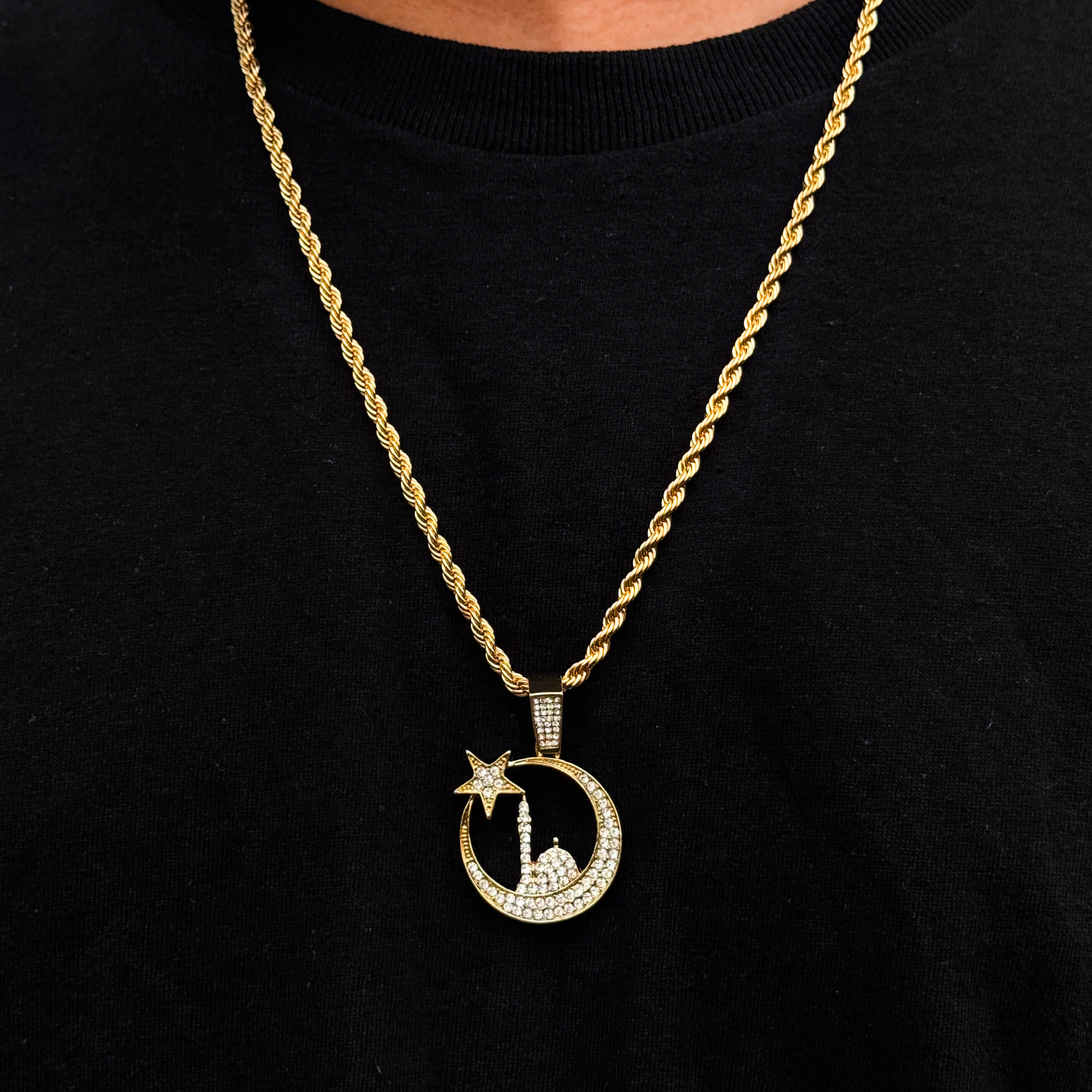 Gold Islamic moon and star mosque pendant on 4mm rope chain displayed worn on black shirt.