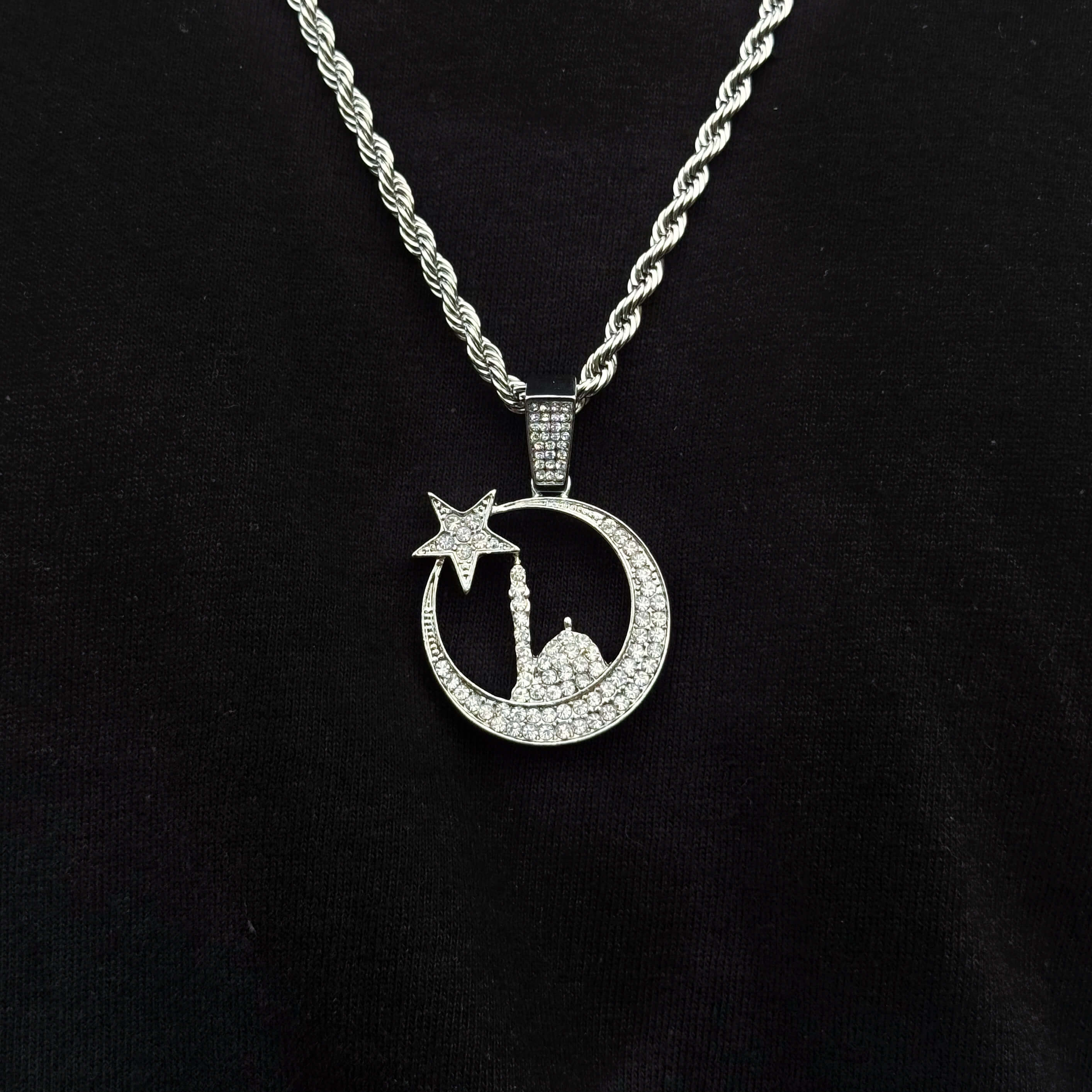 Silver Islamic moon and star mosque pendant on 4mm rope chain shown worn for detail view.