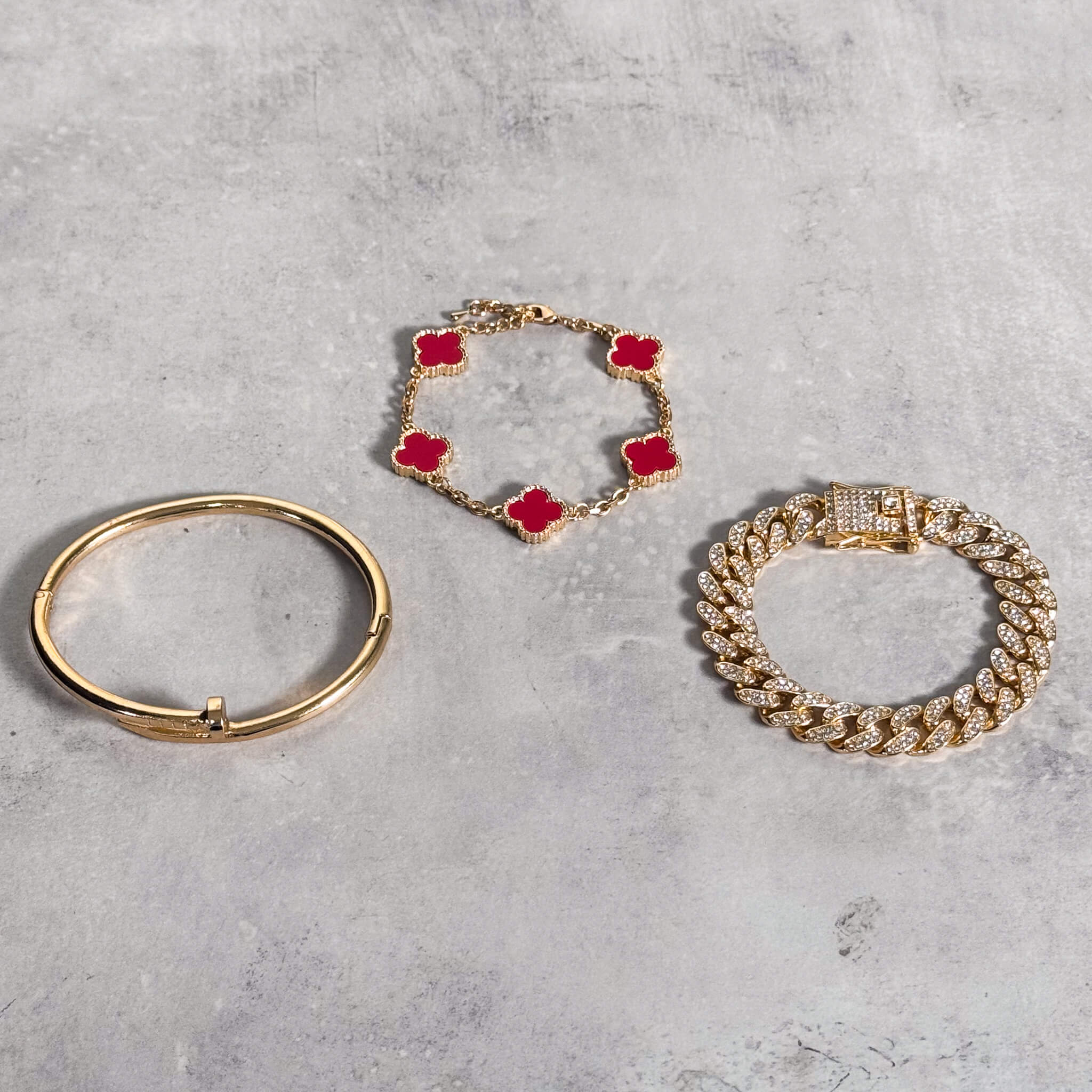 Clover with Cuban Link Bracelet 3-Piece Set in black enamel paired with gold pieces.