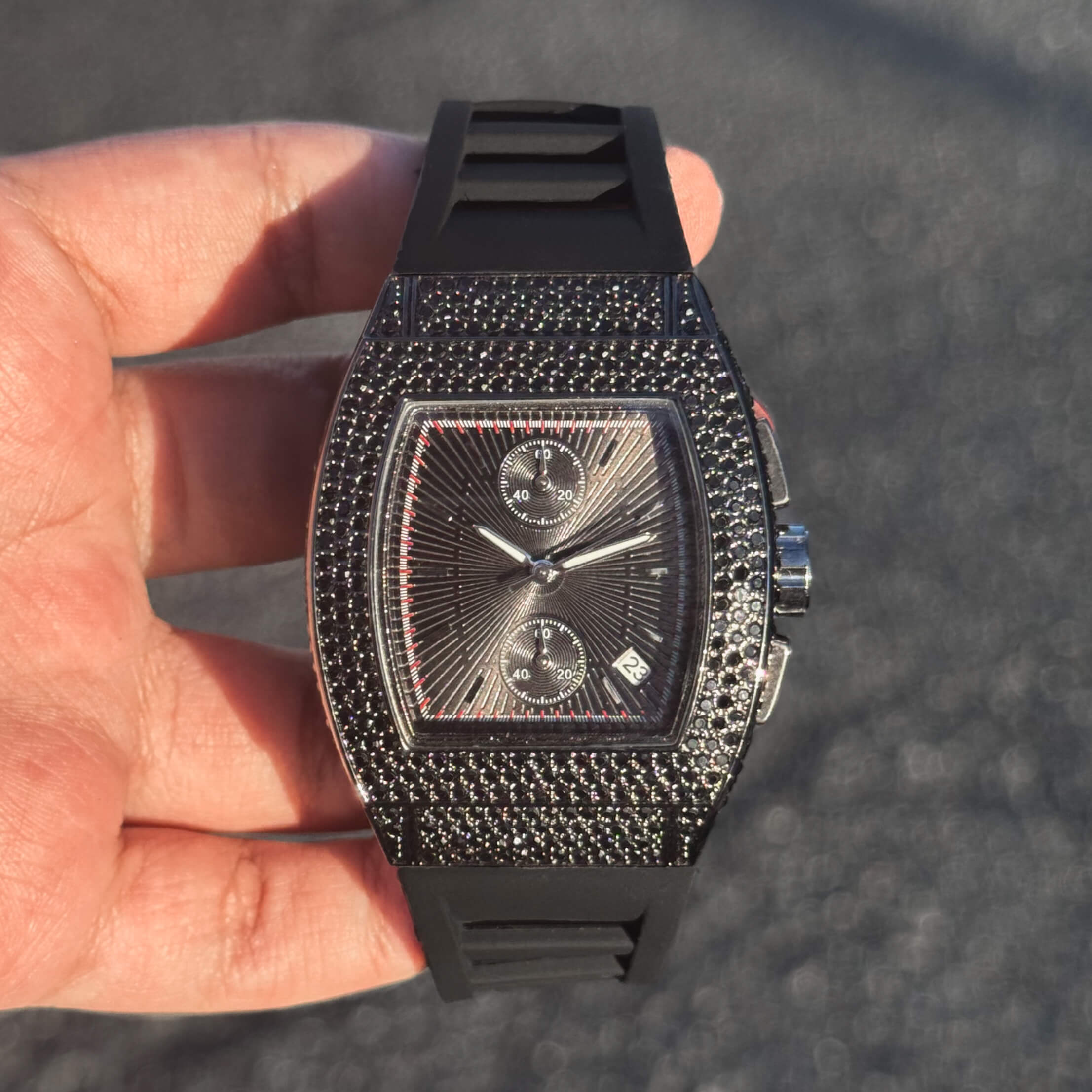 Black Men's 39mm iced tonneau watch with dark dial, black stones and silicone wristband.