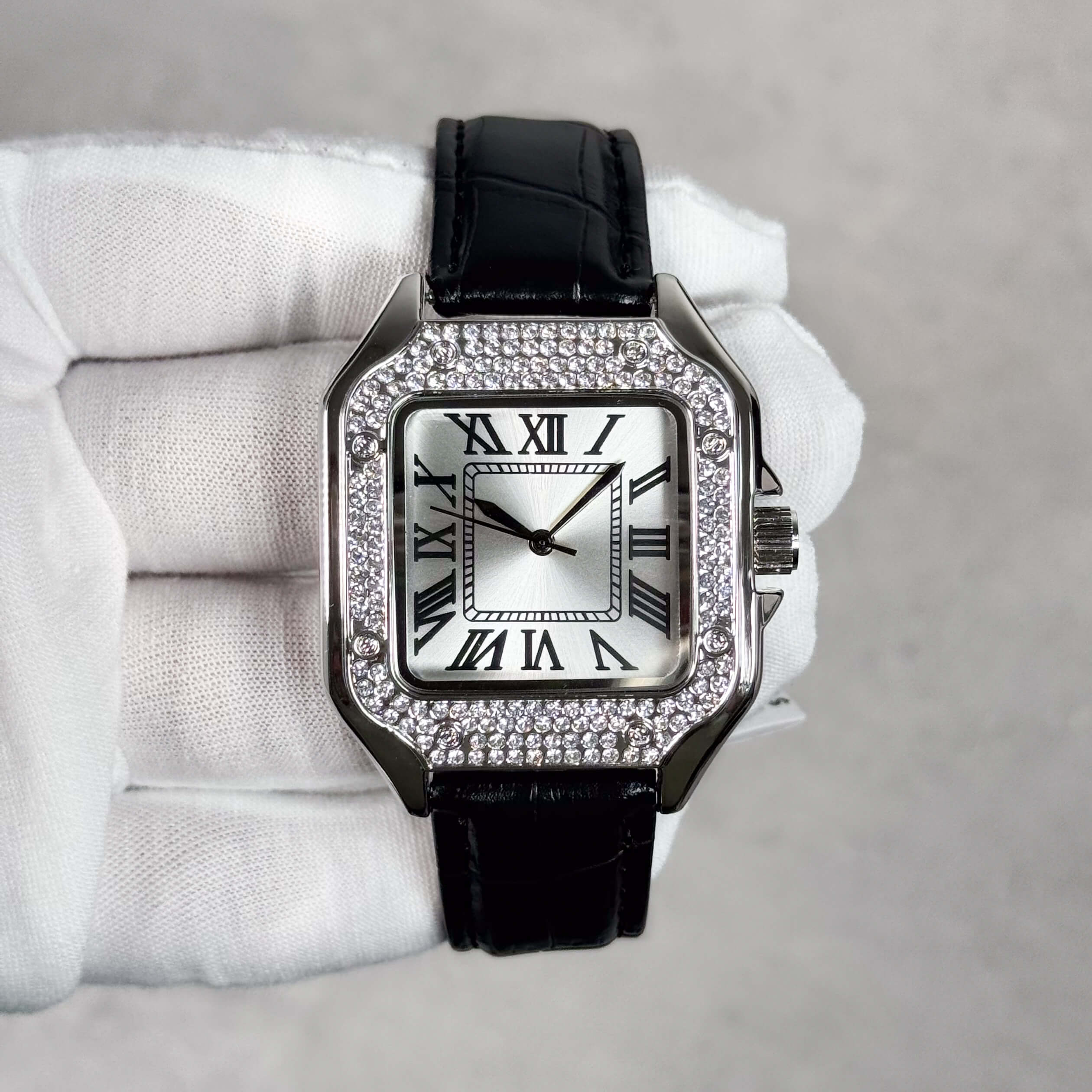 Men's 32mm silver square dial watch featuring crystal bezel and black leather strap.