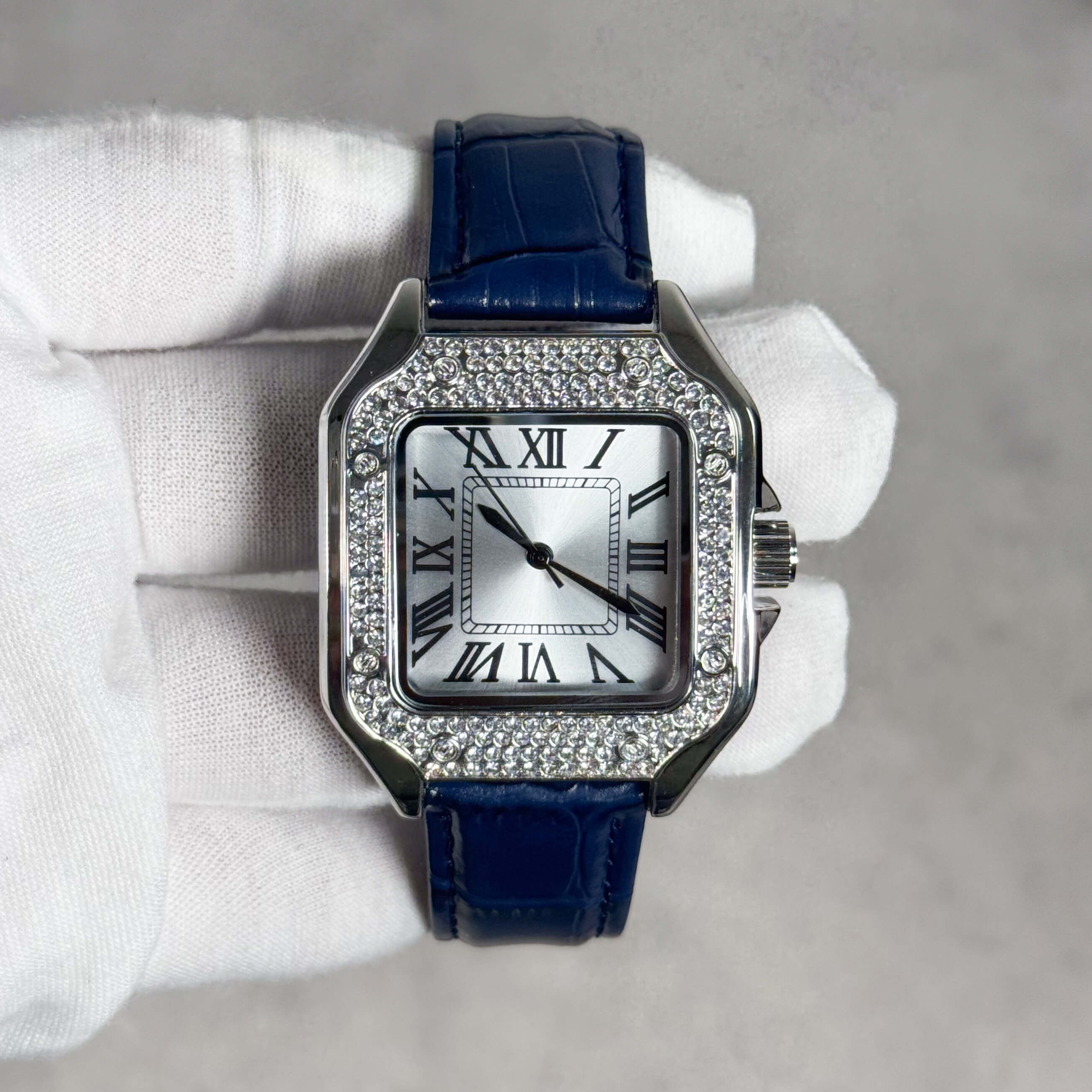 Men's 32mm square silver dial watch with crystal-set bezel and blue crocodile-pattern band.