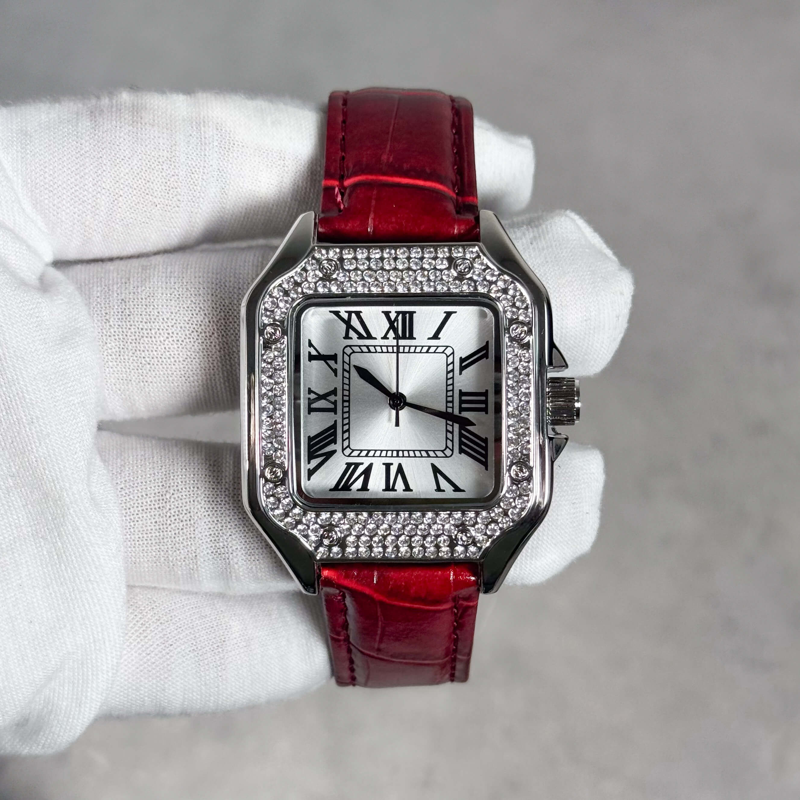 Men's 32mm square silver dial watch with crystal bezel and glossy red leather strap.