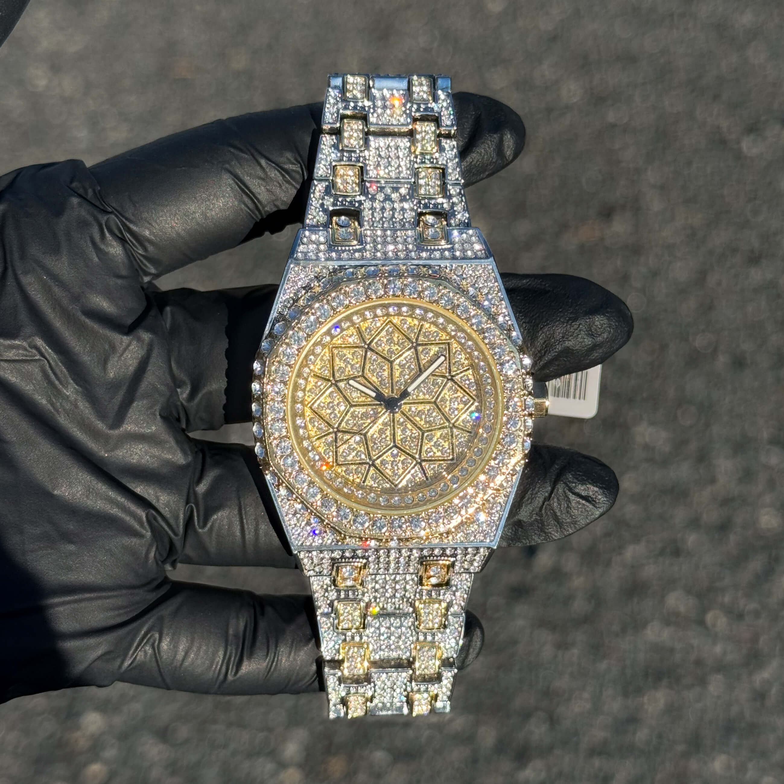 Men's 43mm two-tone iced out octagon watch featuring gold dial accents and full crystal bezel.