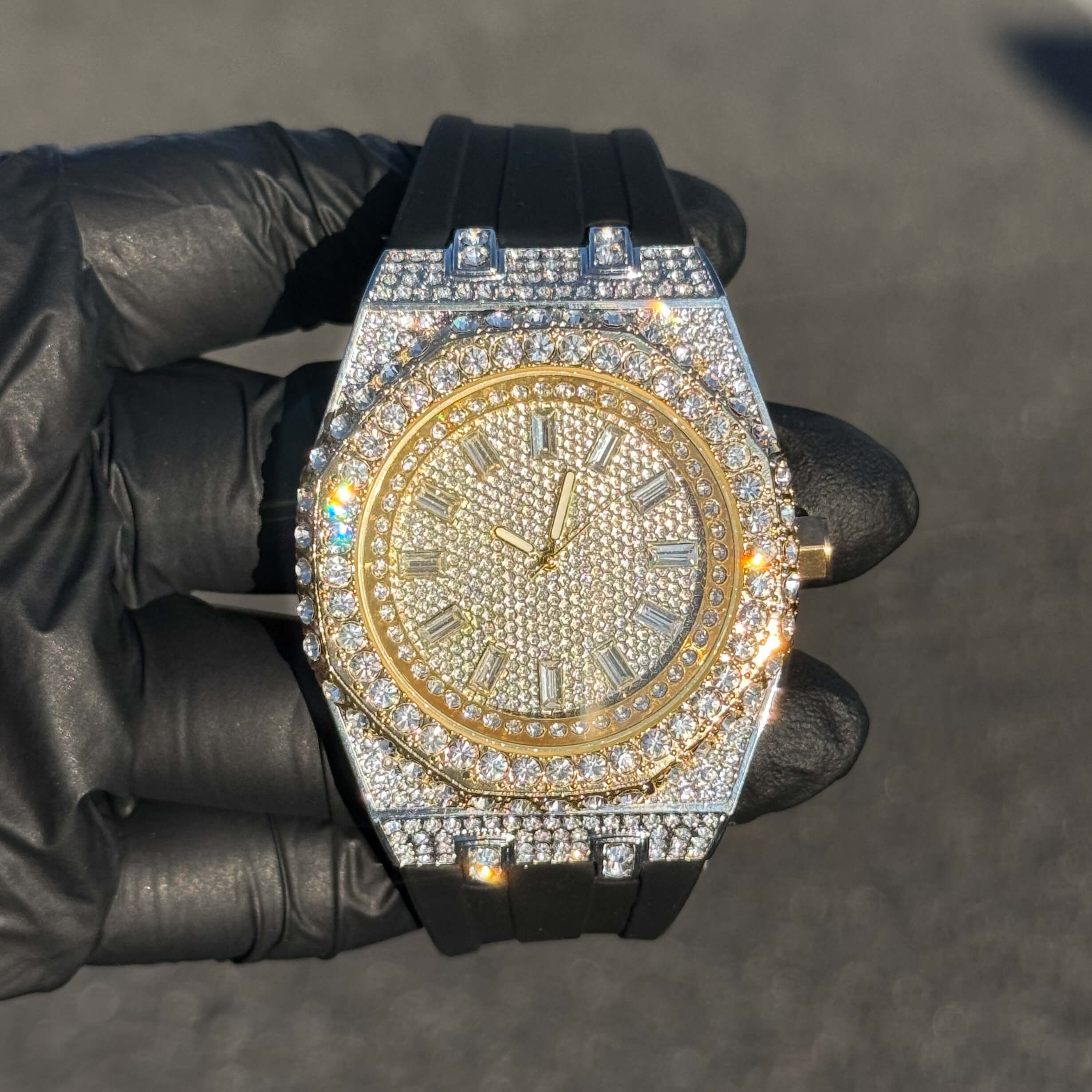 Two-tone gold men's 43mm iced out octagonal dial watch with diamond bezel and silicone band.