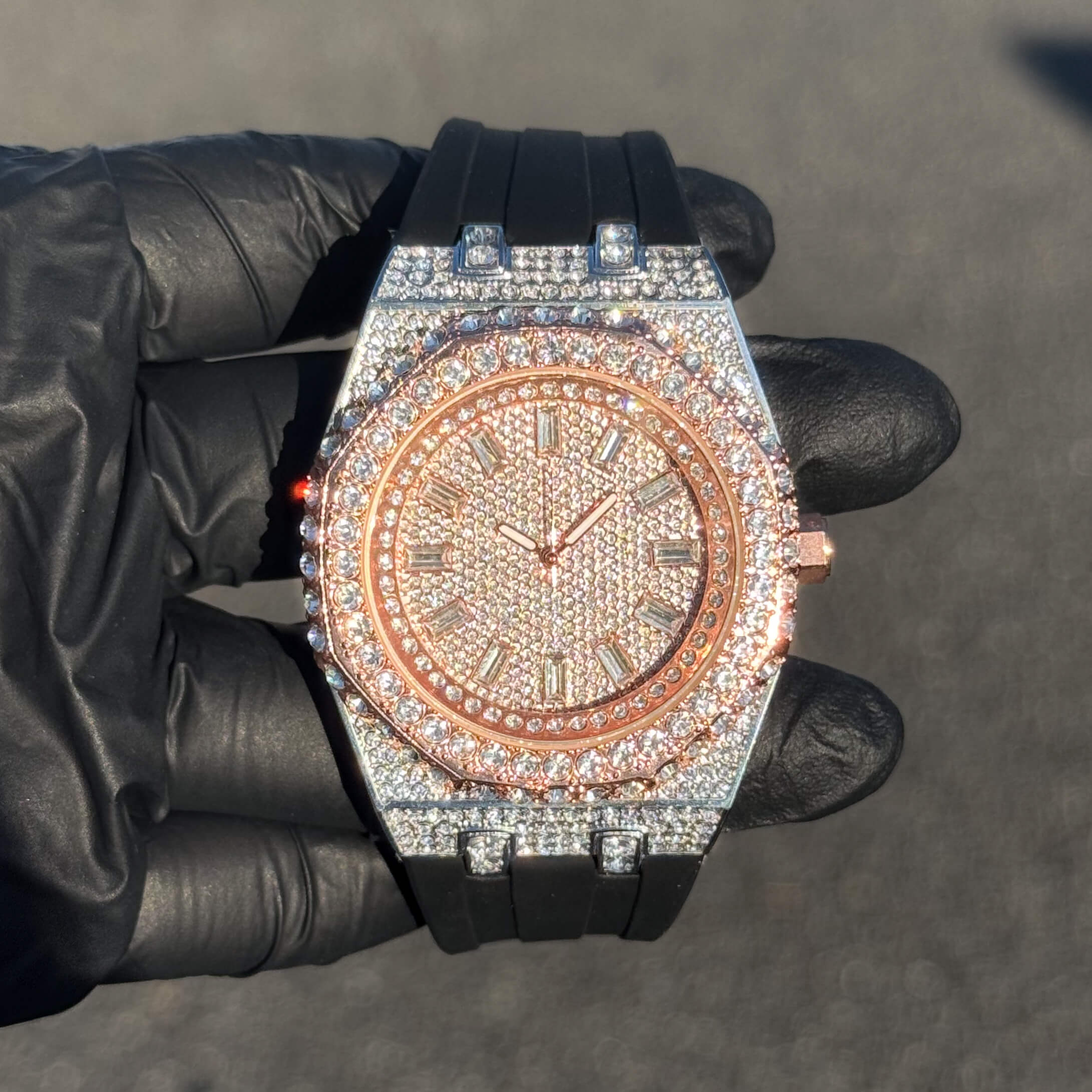 Rose gold men's 43mm iced out octagonal dial watch with pavé stones and black silicone strap.