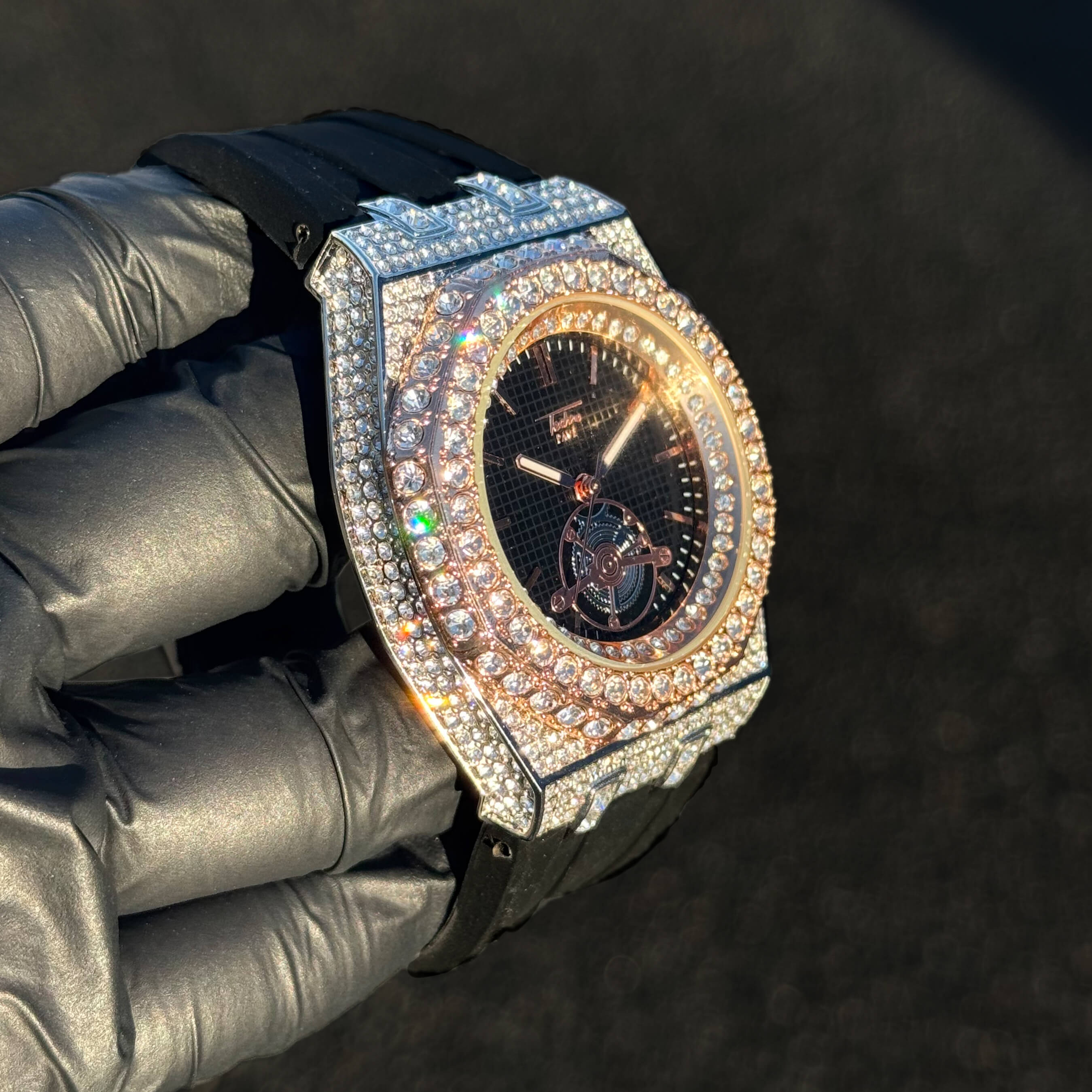 Men's 43mm iced out octagonal watch shown at an angle with rose gold bezel and crystal details.