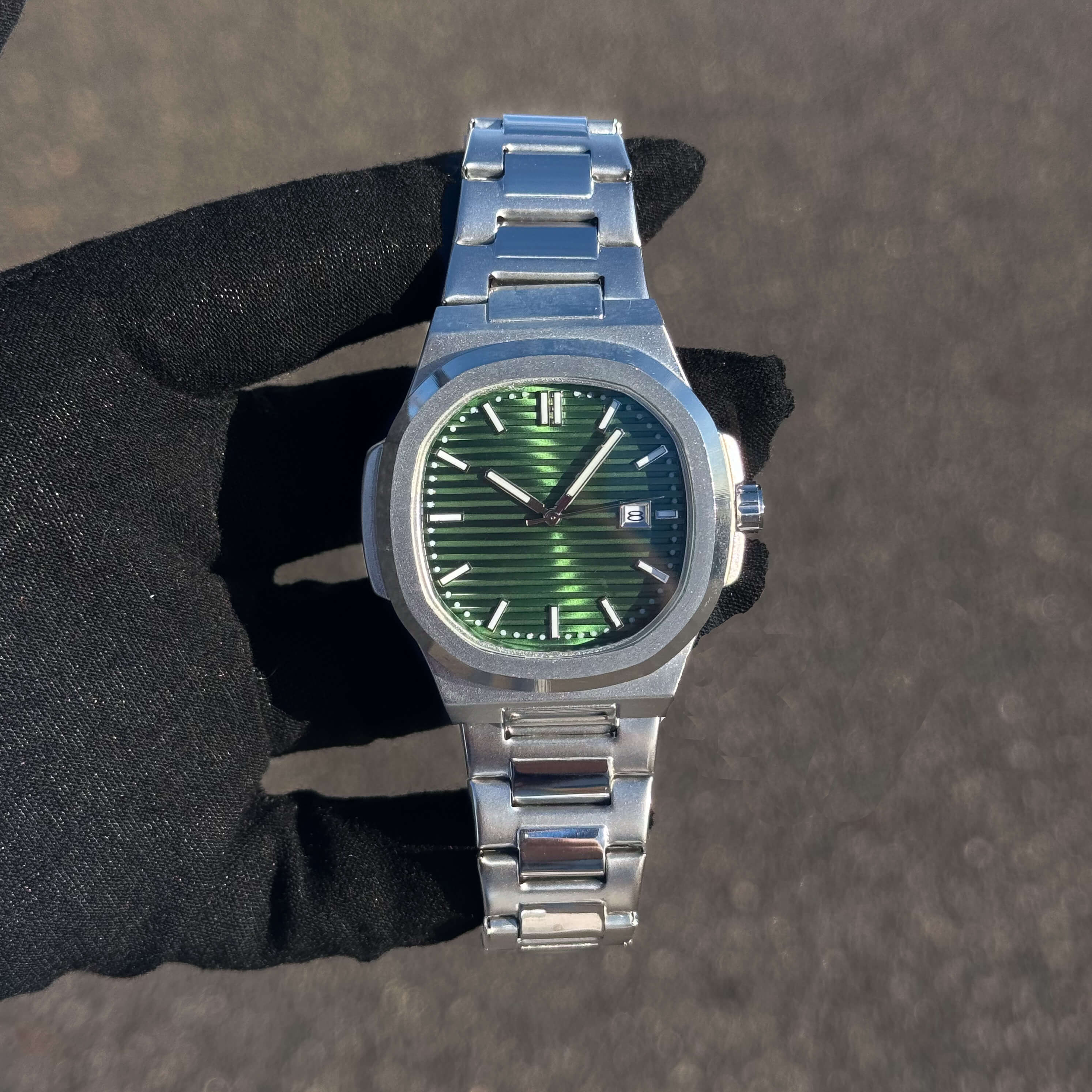 Men’s 42mm Classic Oblong Dial Watch with green striped dial, stainless steel case, and quartz movement.
