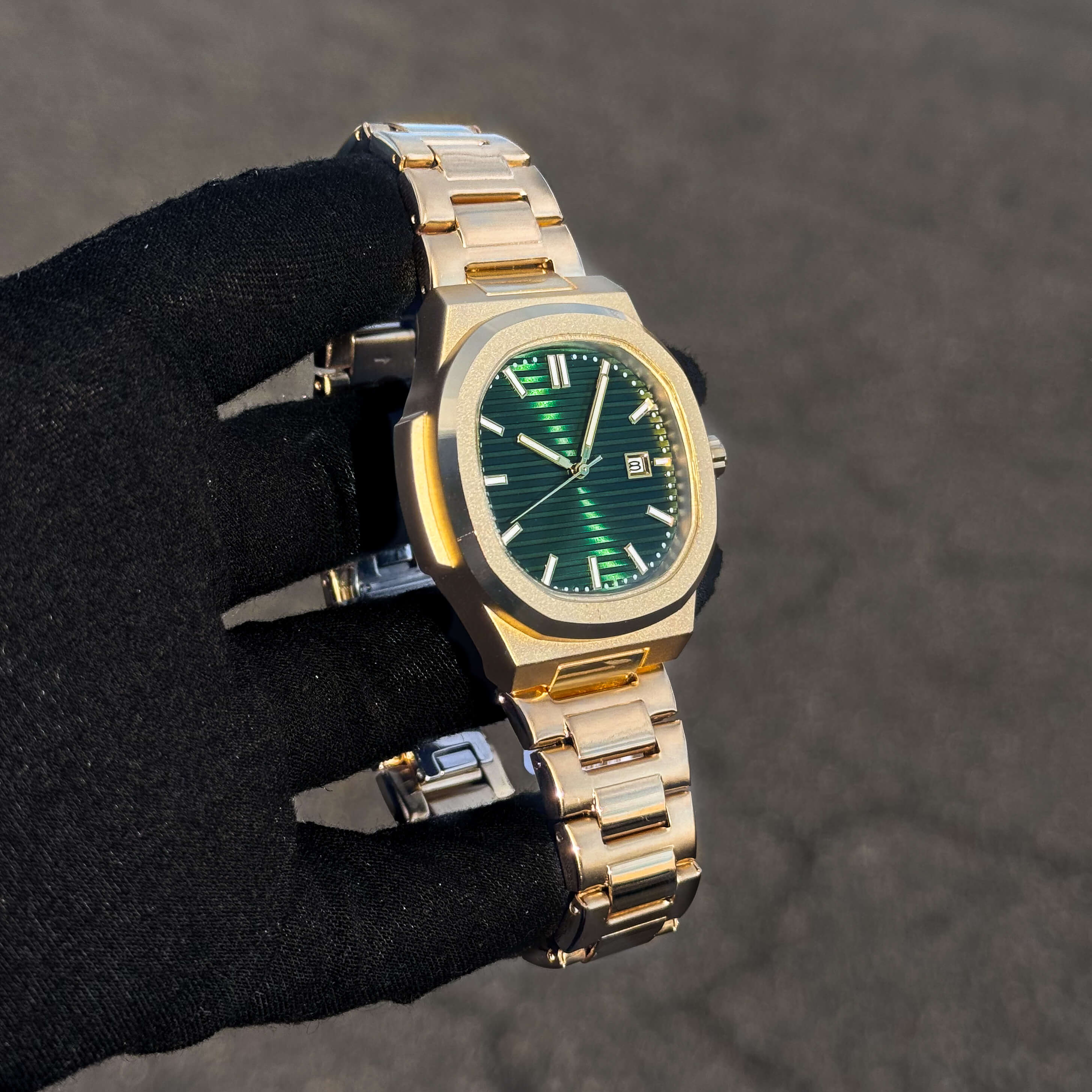 Men’s 42mm Classic Oblong Dial Watch in gold finish with green striped dial and stainless steel bracelet.