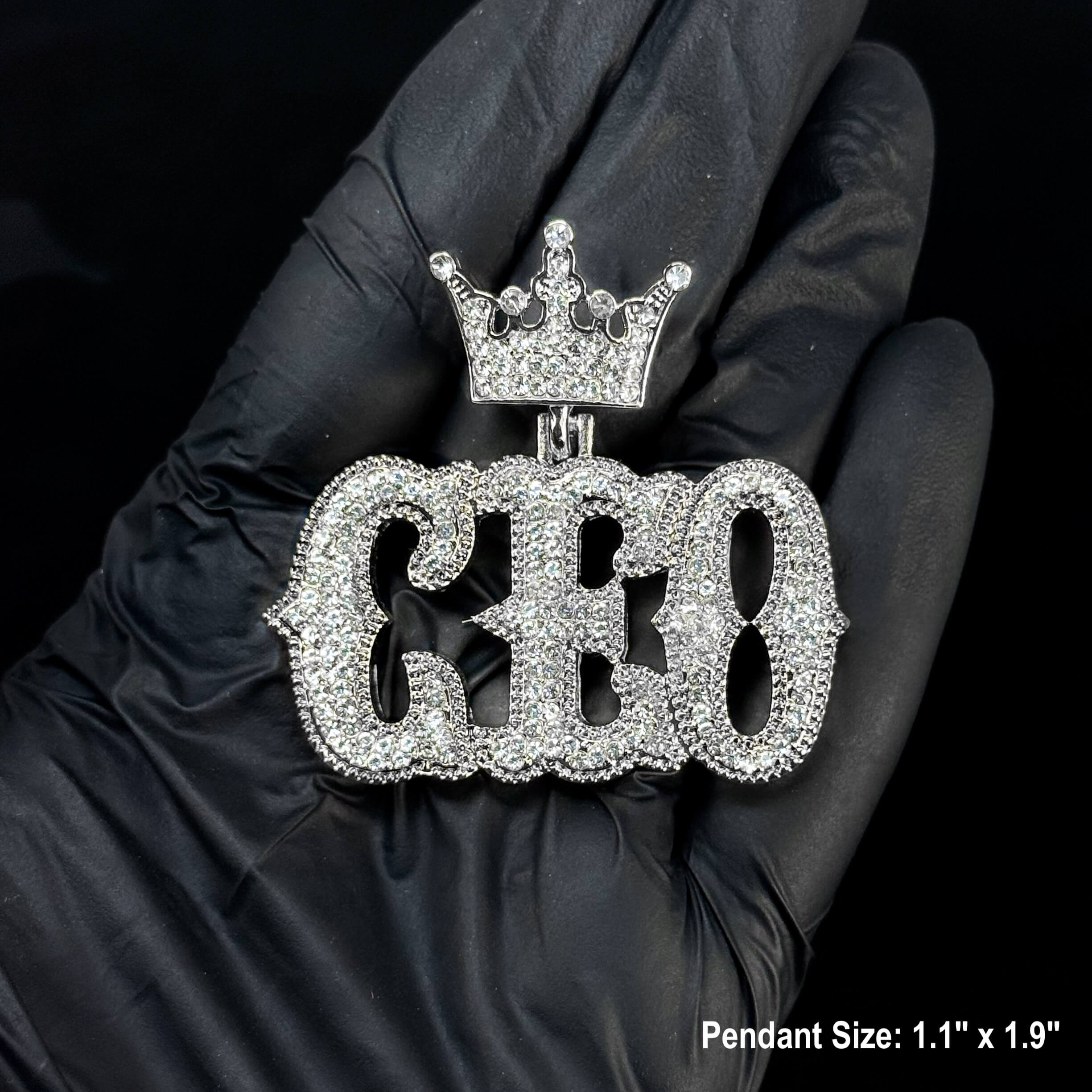 Silver Men's Iced Out CEO Pendant displayed in hand with crown top and sparkling crystals, hip hop chain charm.