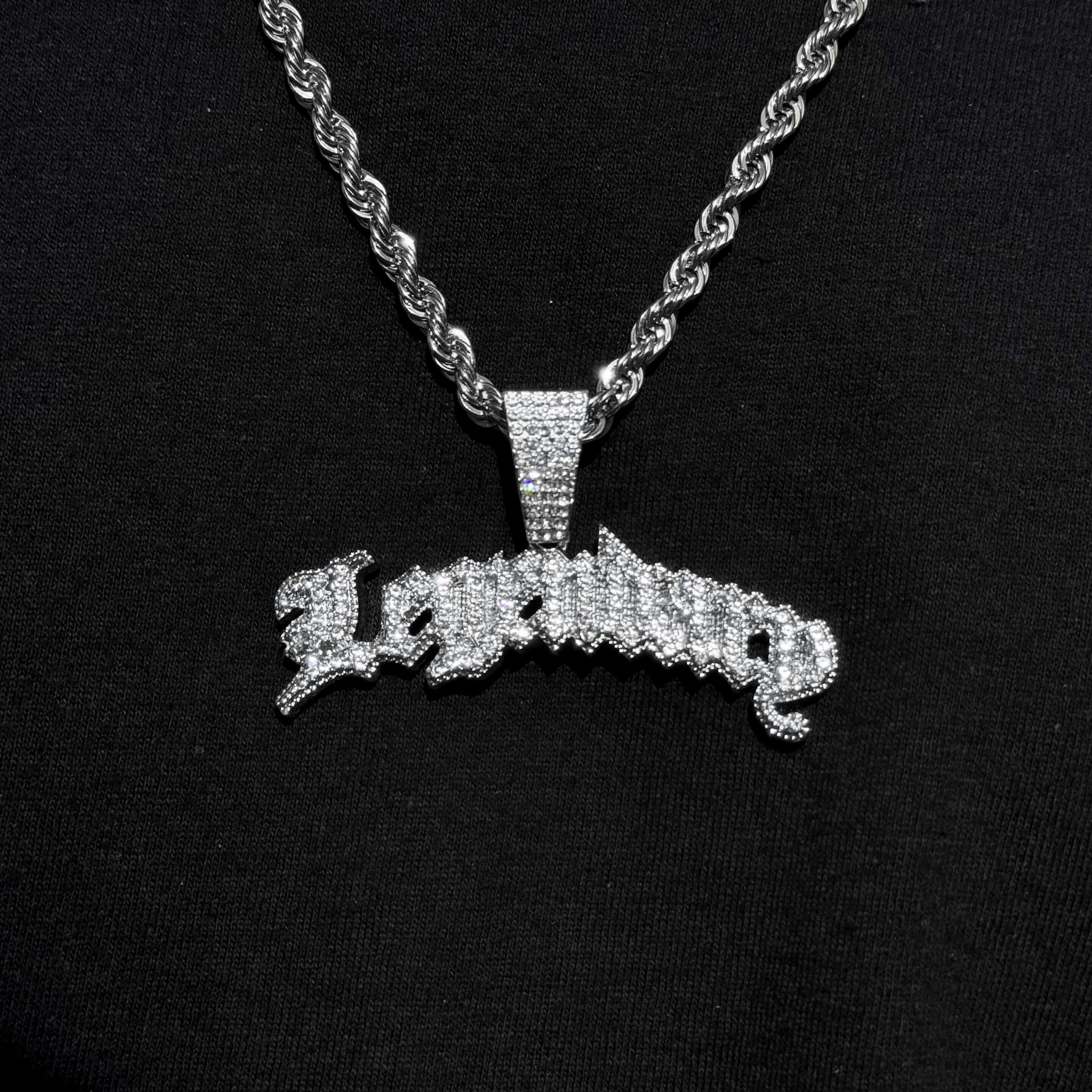 Silver Men's Large Iced Out Legendary pendant on twisted rope chain with glittering crystals.