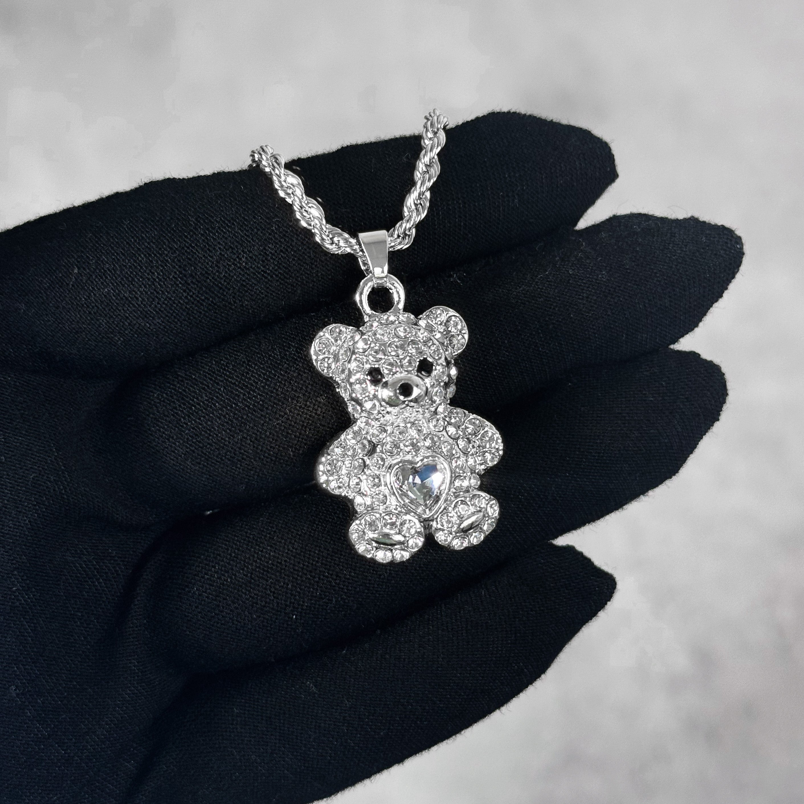 Mini Iced Heart Stone Teddy Pendant silver tone with iced teddy design and heart stone detail.