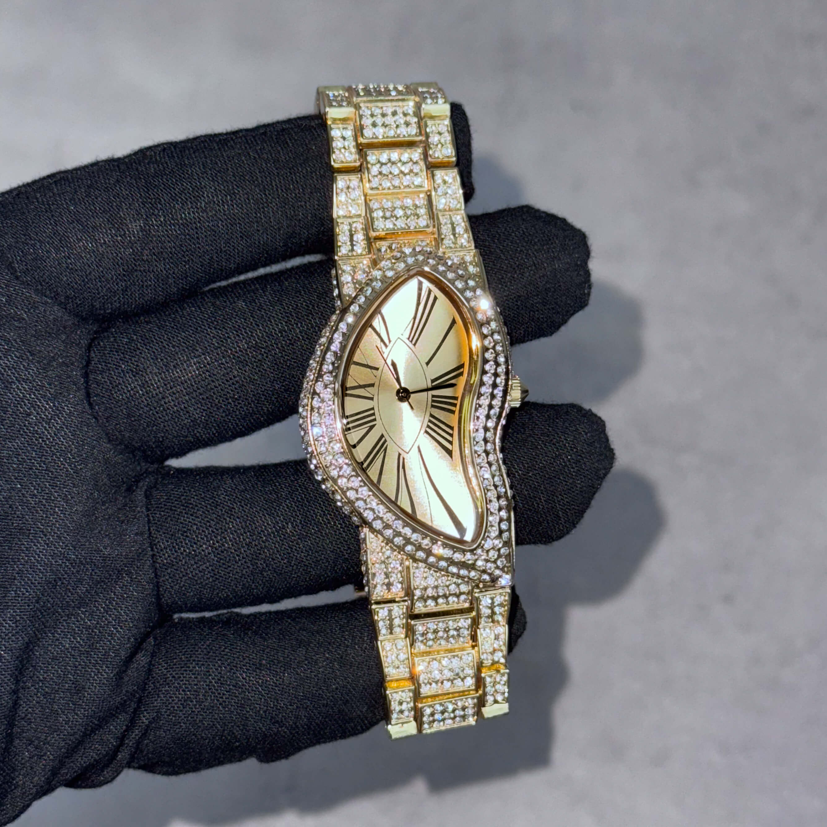 Men’s 30mm gold warped dial watch with crystal-paved bezel and fully iced-out bracelet links.