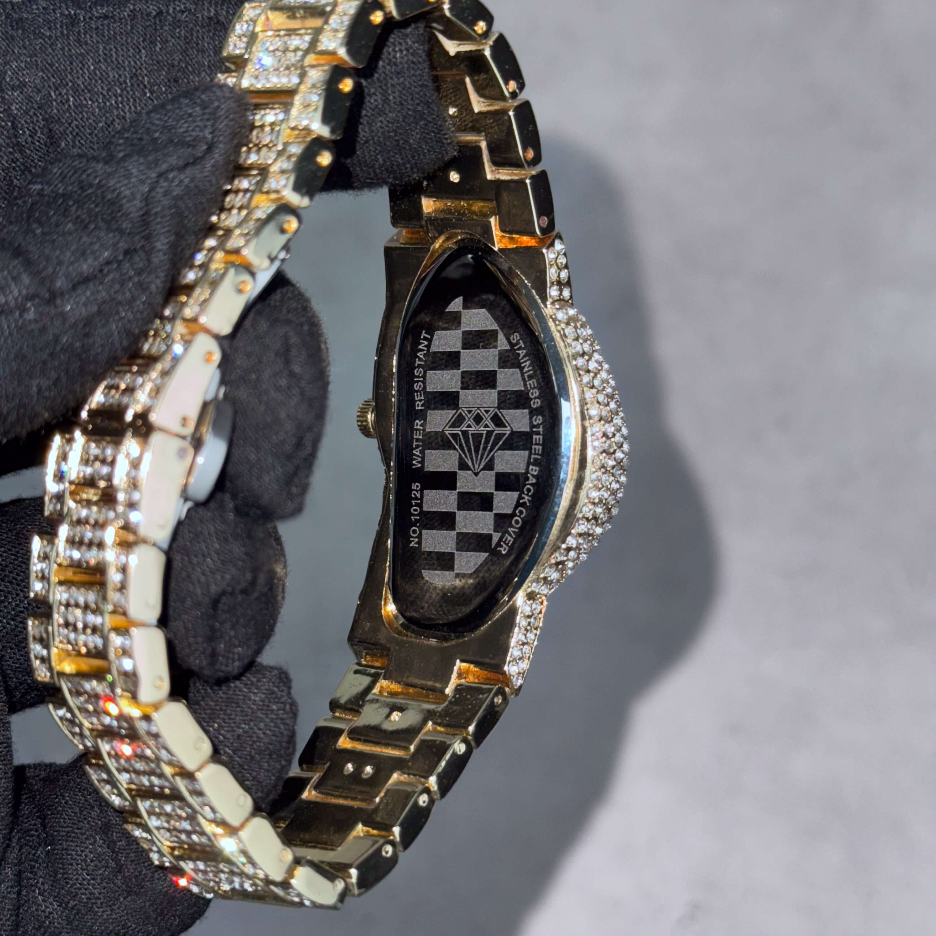 Men’s warped 30mm iced-out watch showing stainless steel back cover and water-resistant case design.