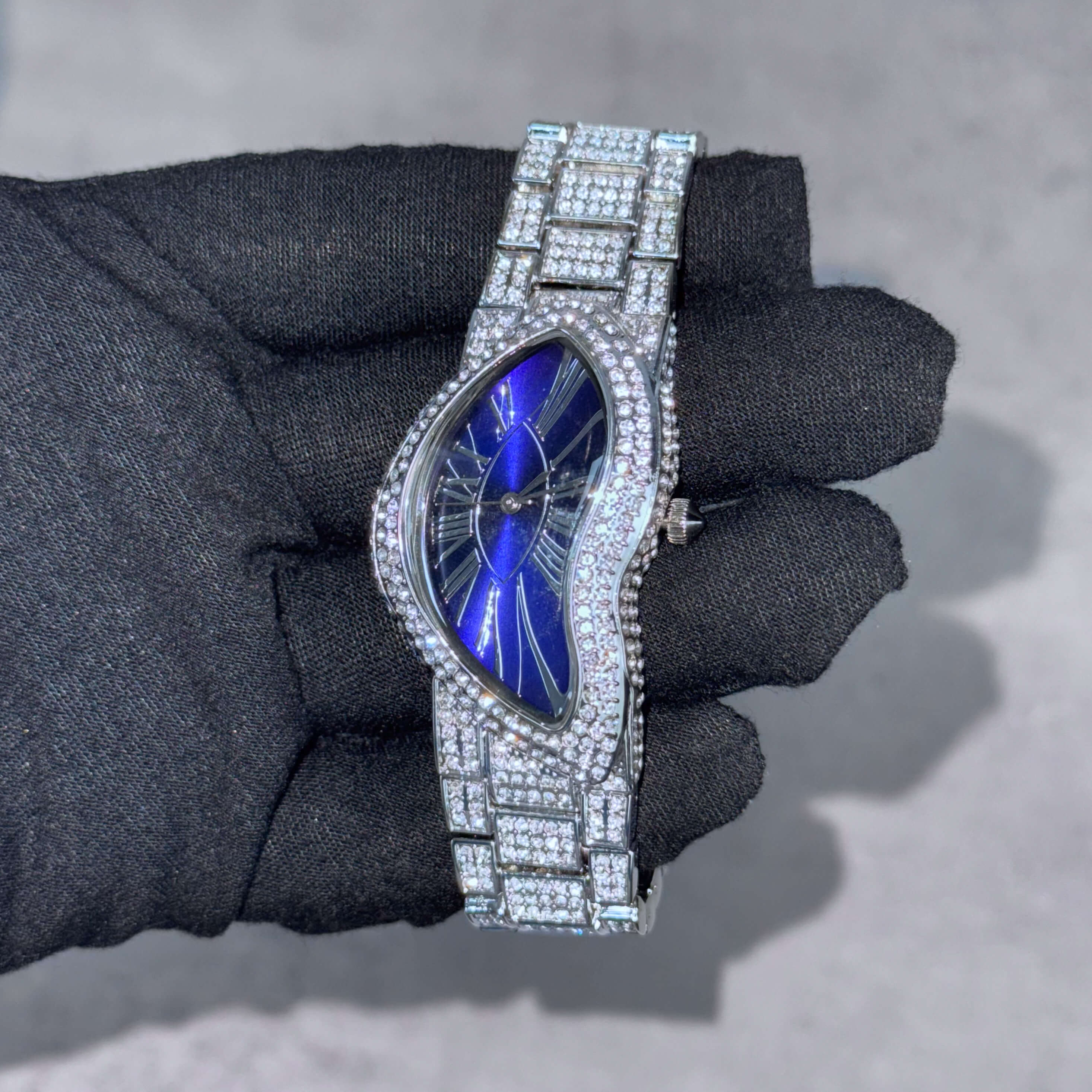 Blue dial men's 30mm iced-out warped watch and curved case for a sleek modern look.
