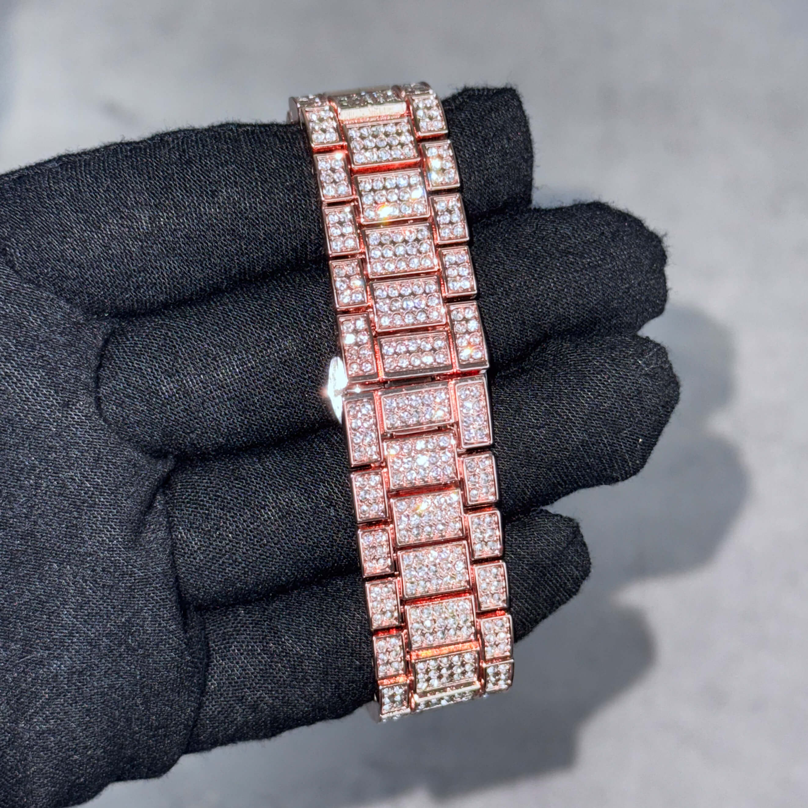 Fully iced-out rose gold watch bracelet featuring multi-row crystal links for men’s luxury warped watch.