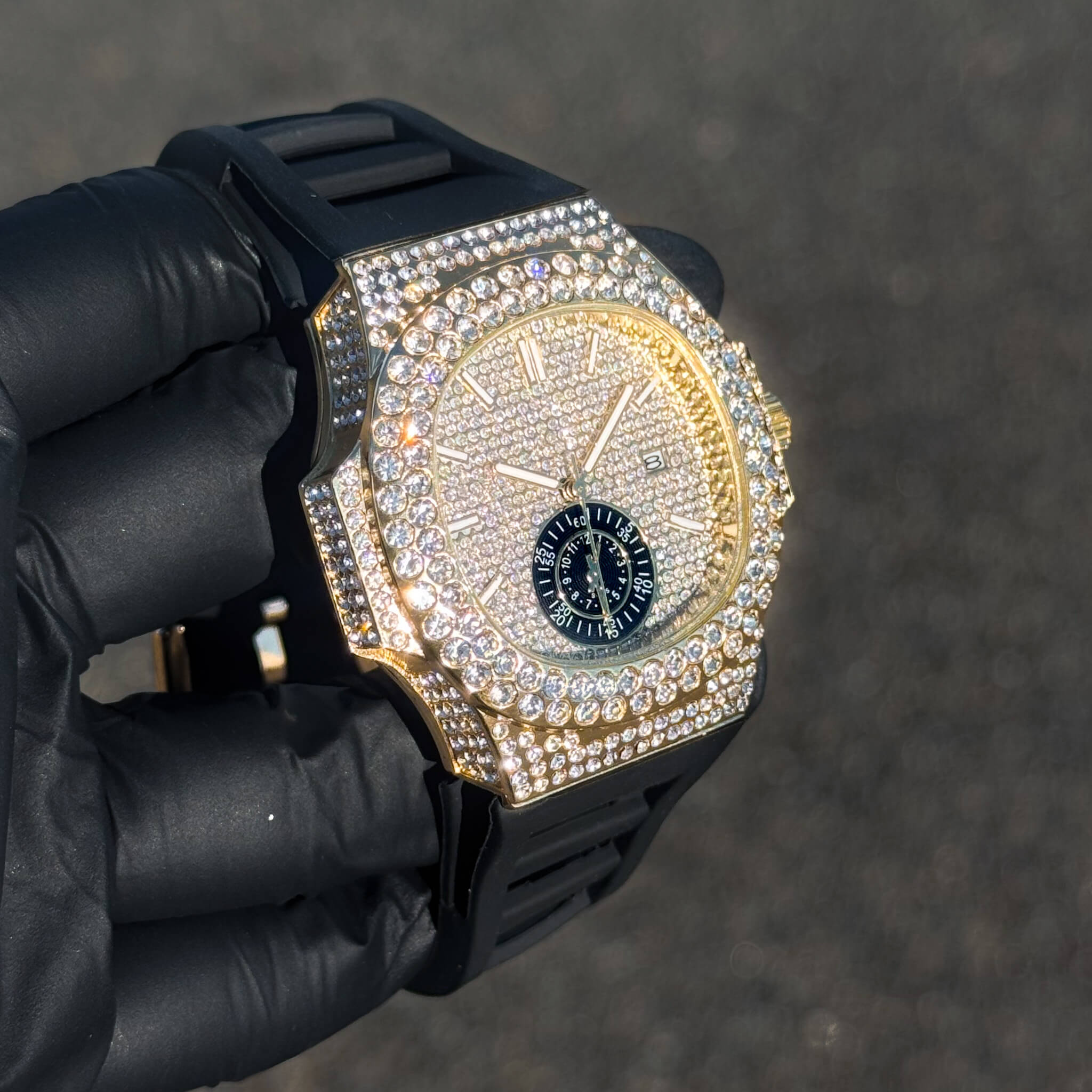 Men's 43mm gold diamond watch with iced oblong bezel, silicone strap, and luxury paved dial.