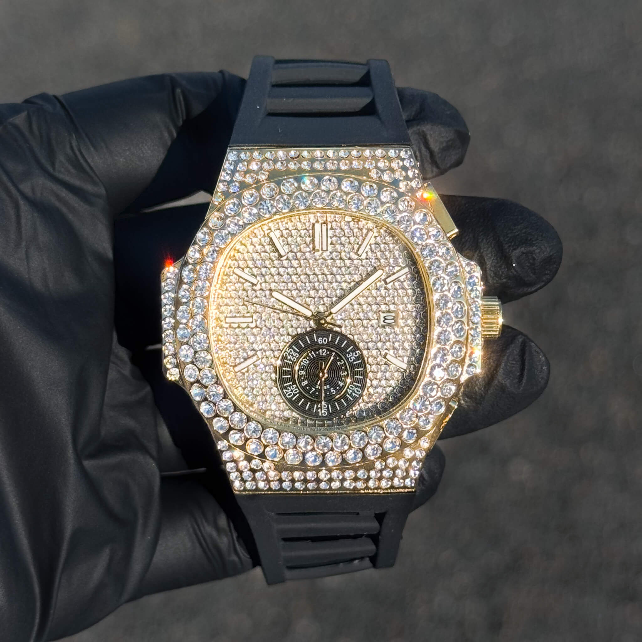 Men's 43mm gold iced out oblong bezel watch with silicone band and full diamond-paved dial.