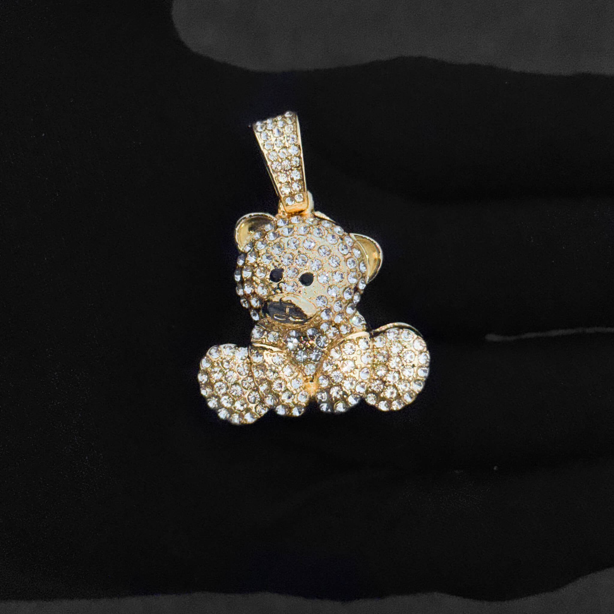 Close-up of gold iced-out 32mm bear pendant featuring pavé crystals and polished finish for women.