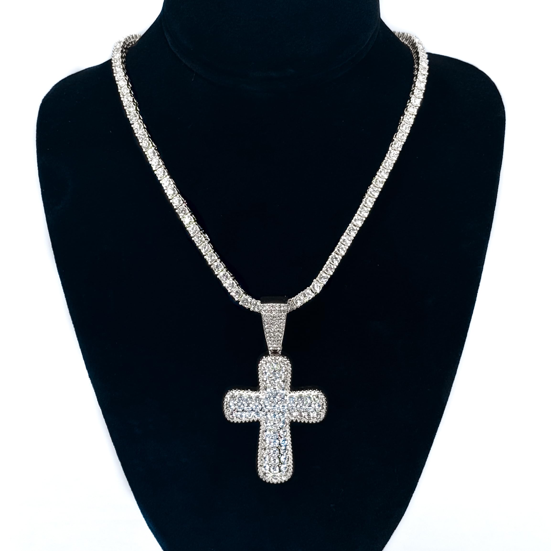 Ladies 40mm iced-out silver cross pendant necklace with 4mm tennis chain shown on black display stand.