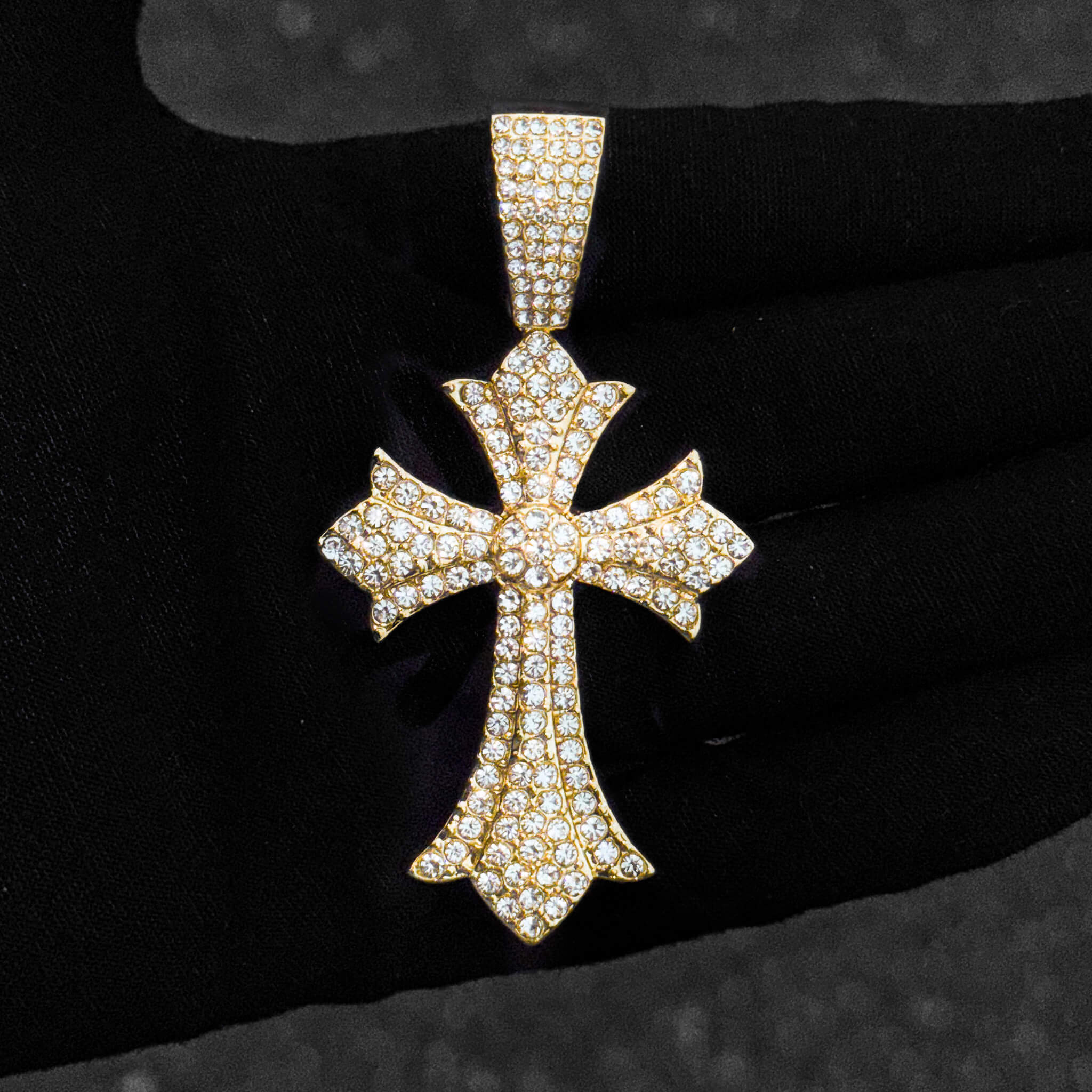 Gold 40mm iced-out men’s cross pendant covered in pavé clear stones with detailed design.