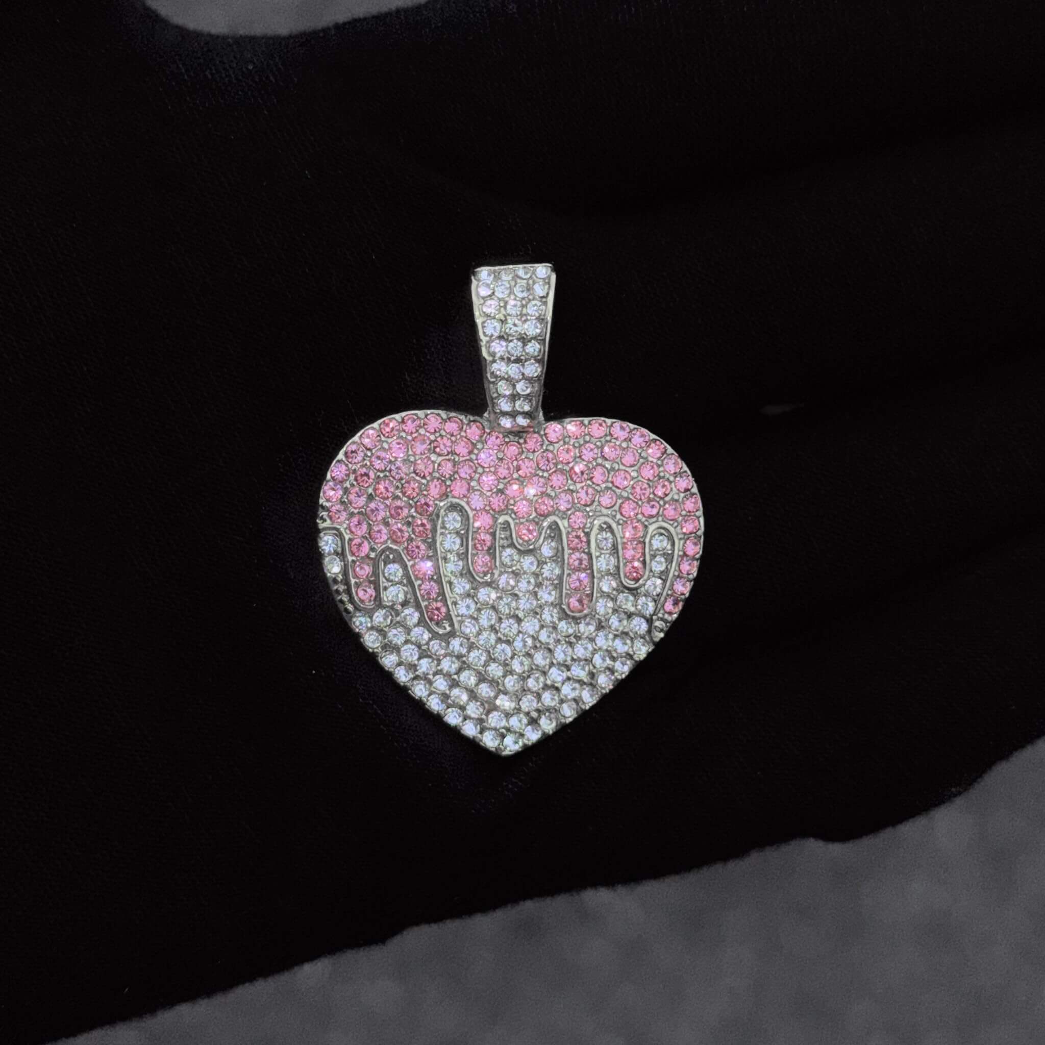 Ladies 32mm iced-out silver Heart pendant necklace with 4mm rope chain shown on black display bust.