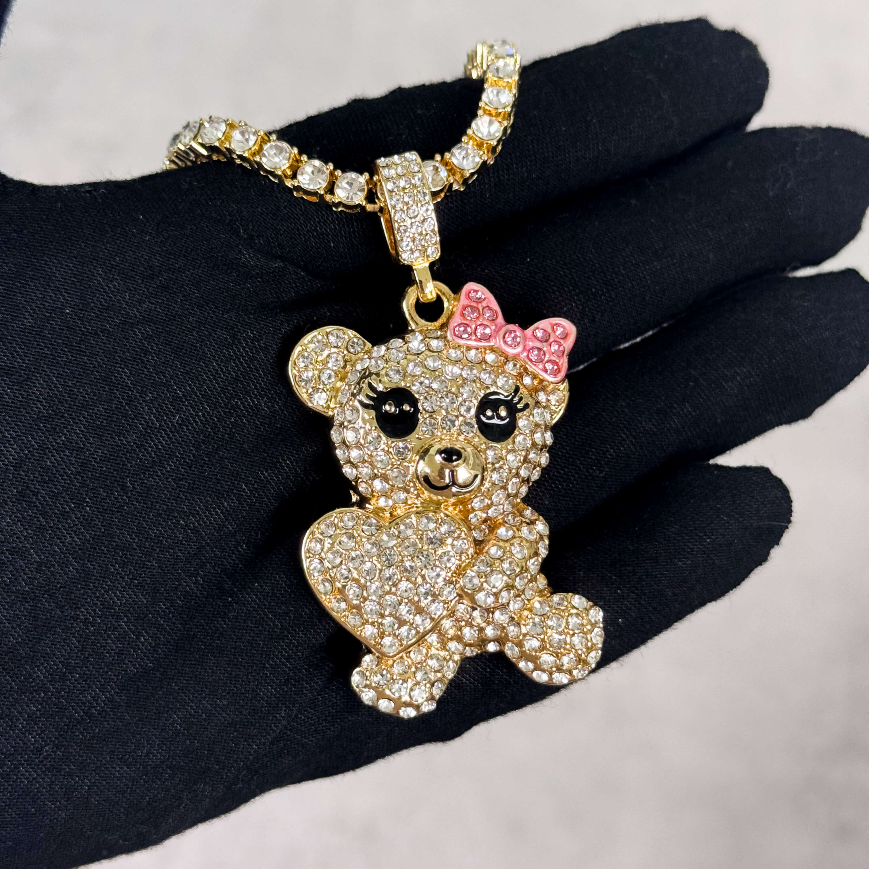 Gold Iced Out Heart Bear Pendant with Tennis Chain worn on hand, iced crystal teddy necklace.