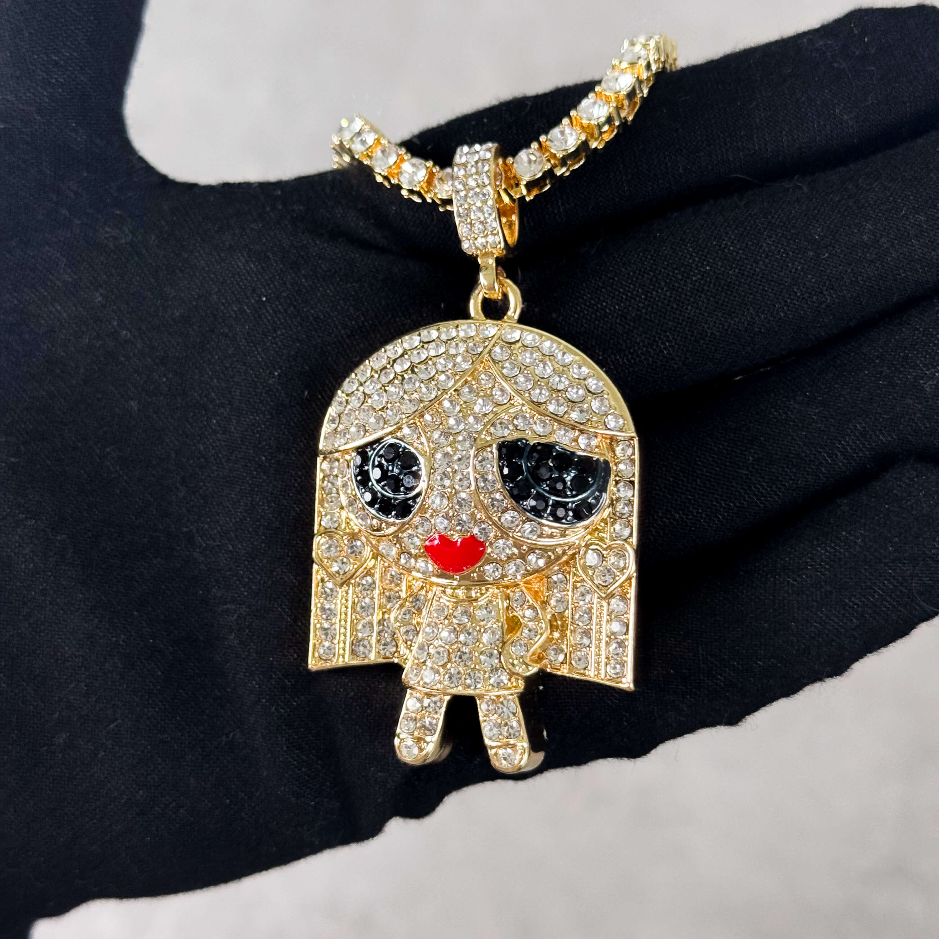 Gold Iced Out Stand on Business Doll Pendant with Tennis Chain held in hand, fully iced CZ design.