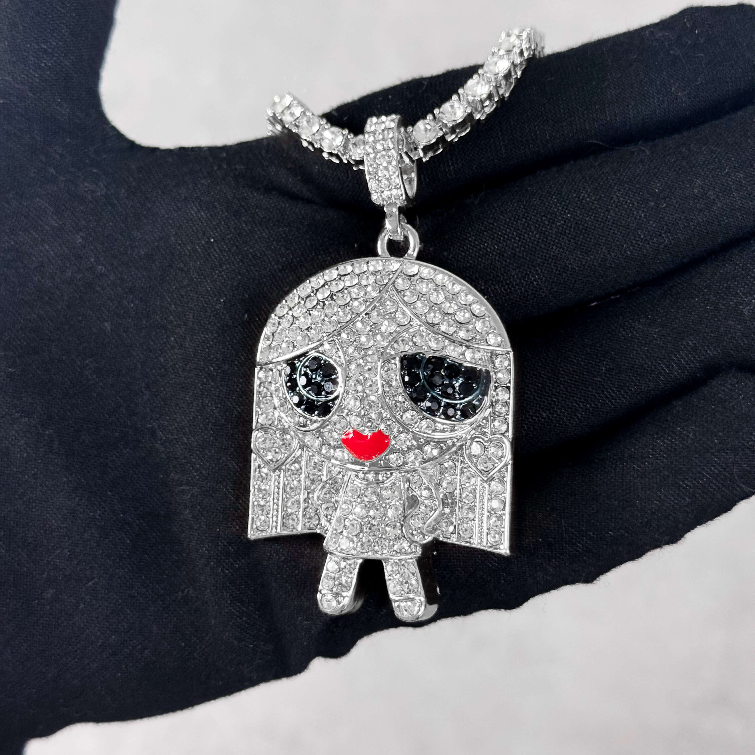 Silver Iced Out Stand on Business Doll Pendant with Tennis Chain shown in hand, pavé CZ detail.