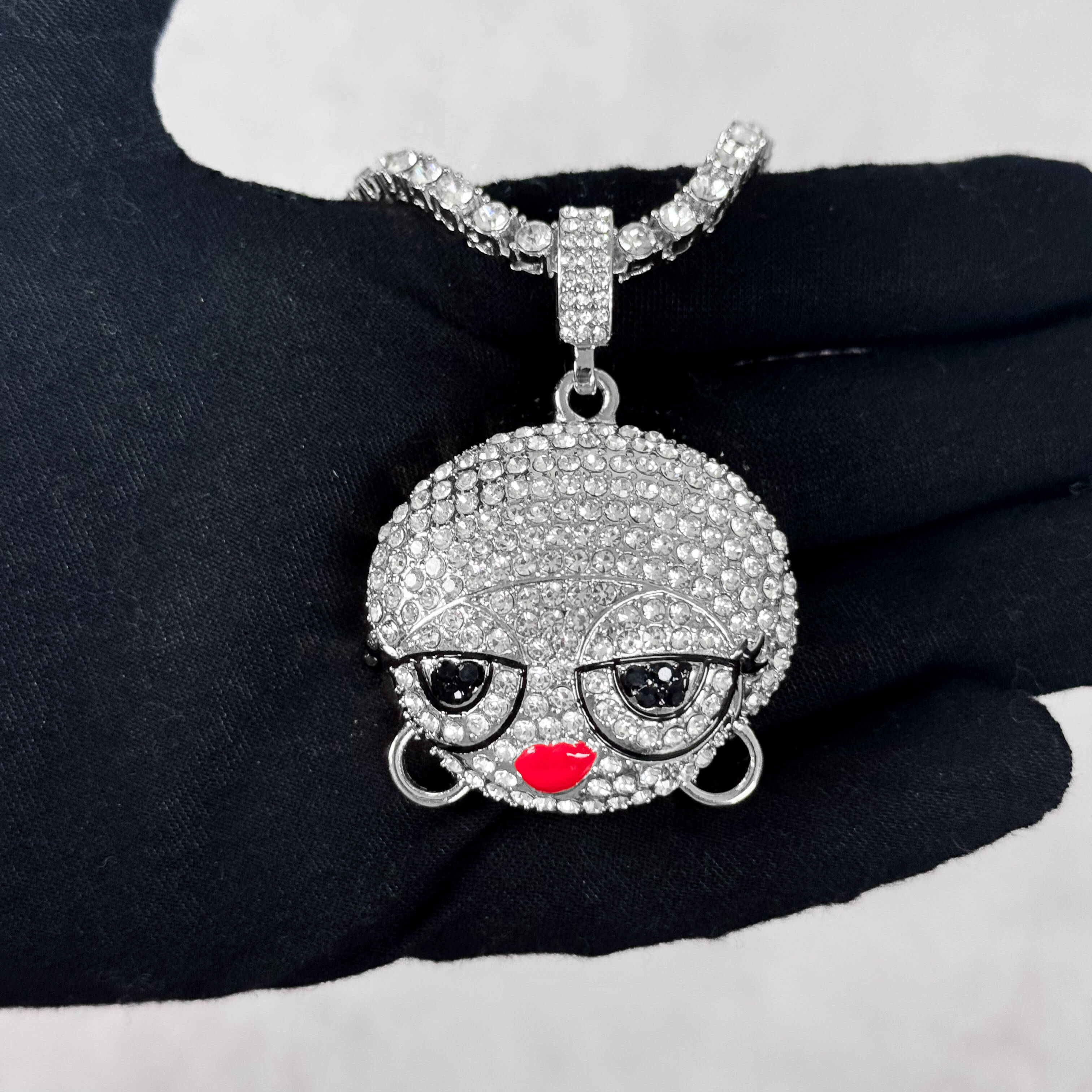 Silver Iced Out Diva Doll Pendant with Tennis Chain shown in hand, fully iced CZ design.