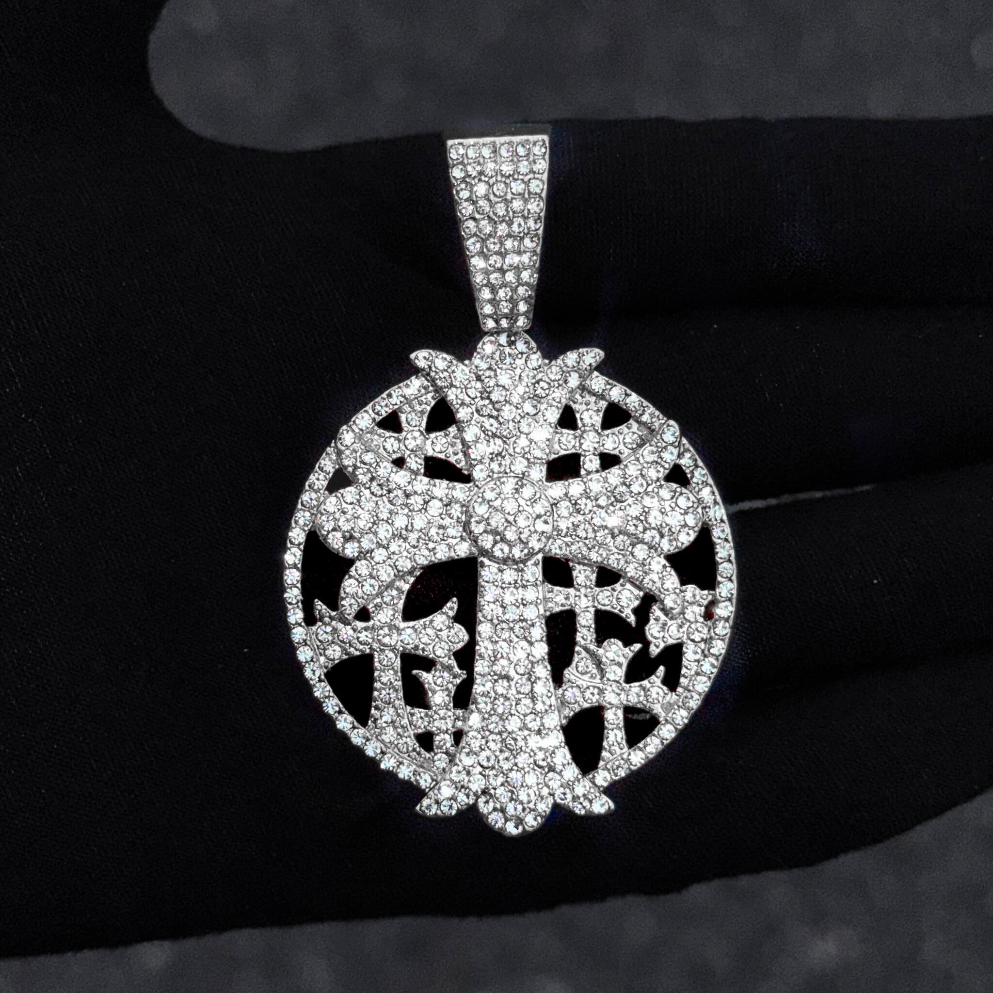 Detailed close-up of silver 44mm iced-out cross medallion pendant with dense round crystal accents.