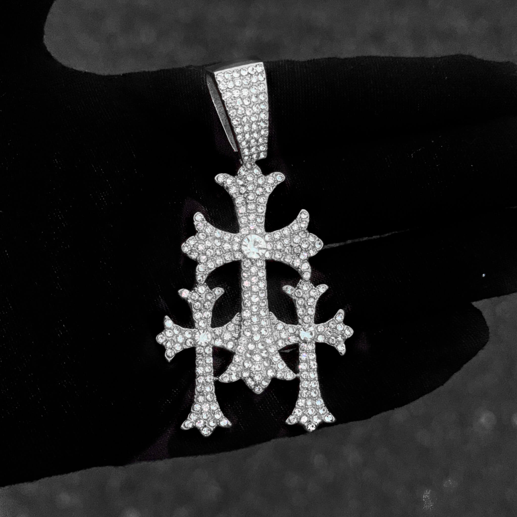 Detailed close-up of silver 40mm iced-out cross pendant with shimmering round stones.
