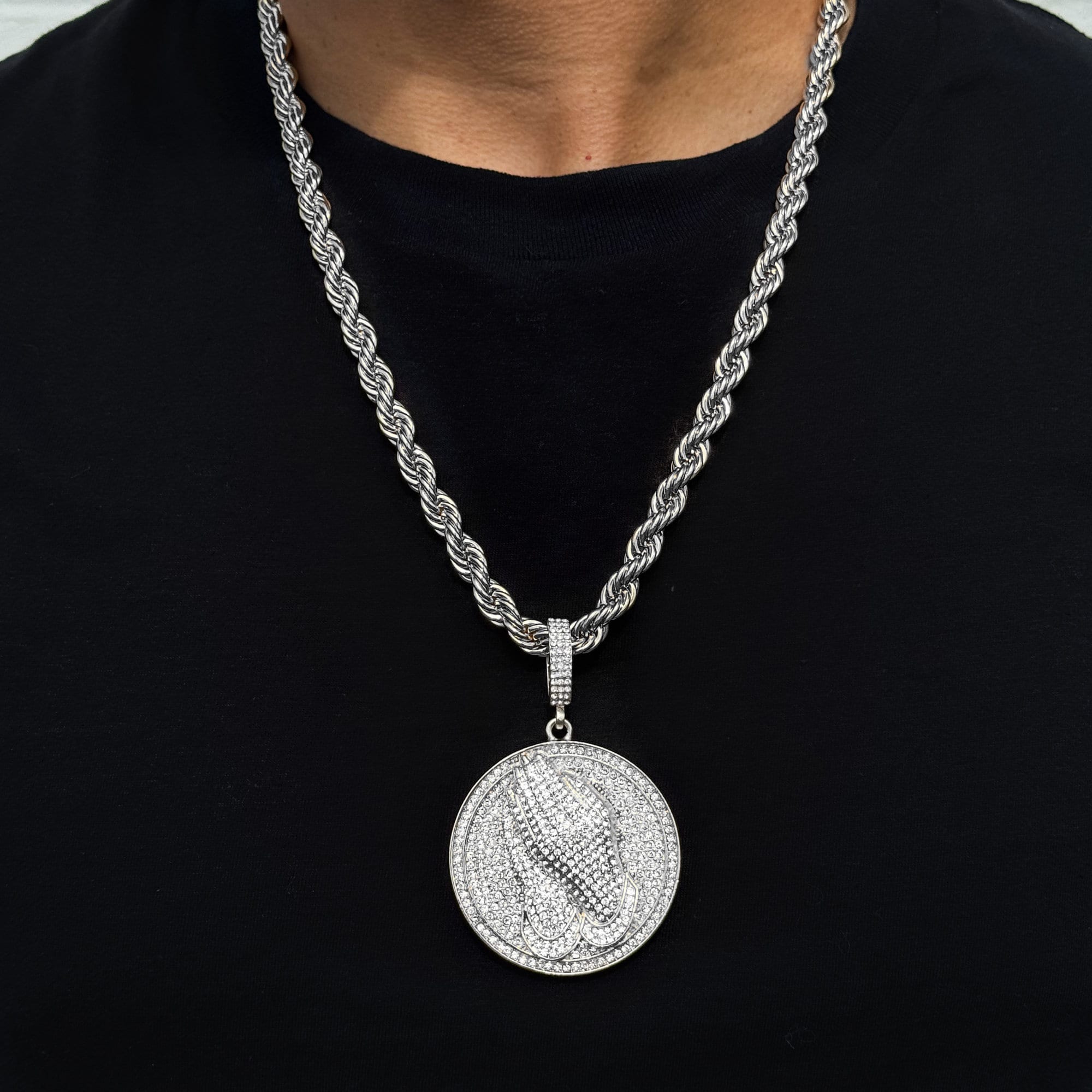 Men’s large silver iced-out praying hand medallion pendant on an 8mm rope chain with detailed stones.