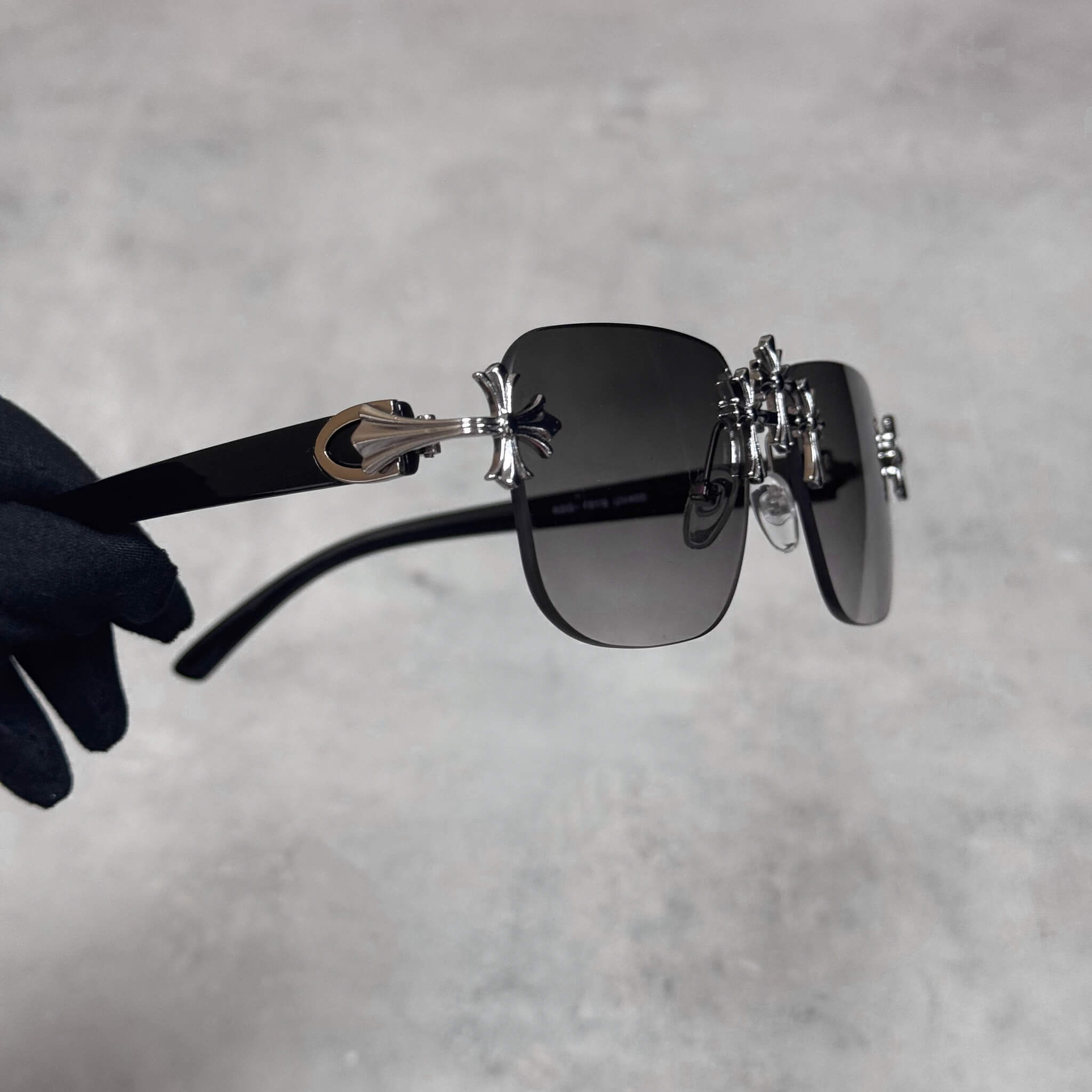 Solid Triple Cross Sunglasses with smoke lens, silver cross temples, and sleek black arms.