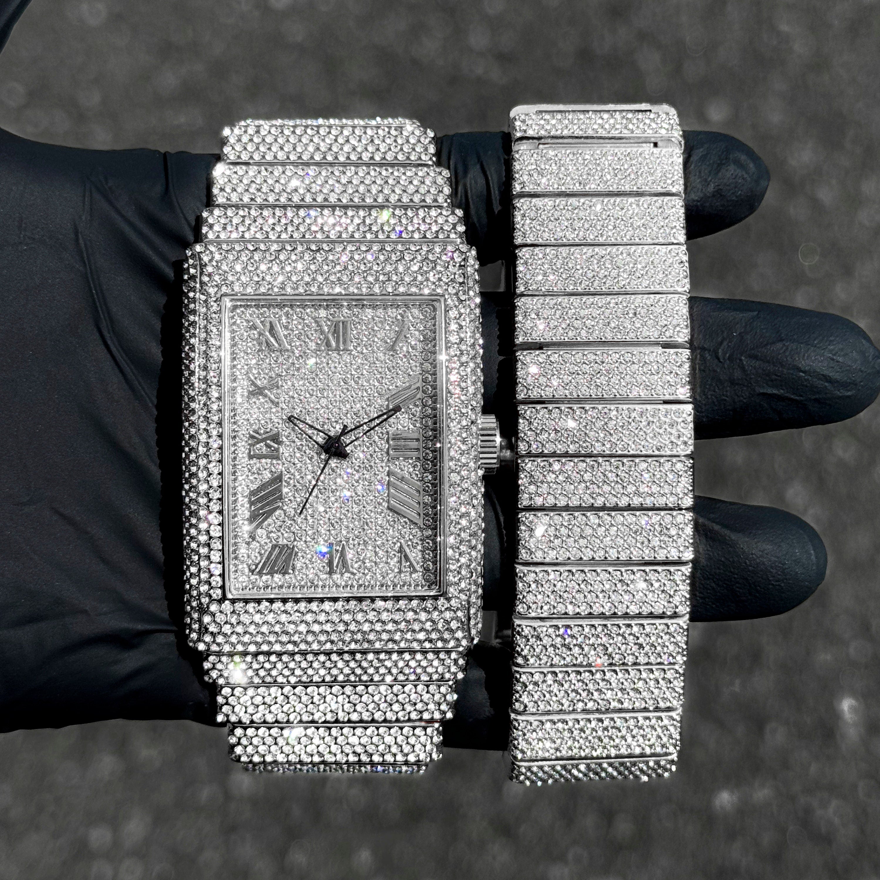Men's 40mm silver fully iced out watch with matching diamond bracelet set shown in hand.