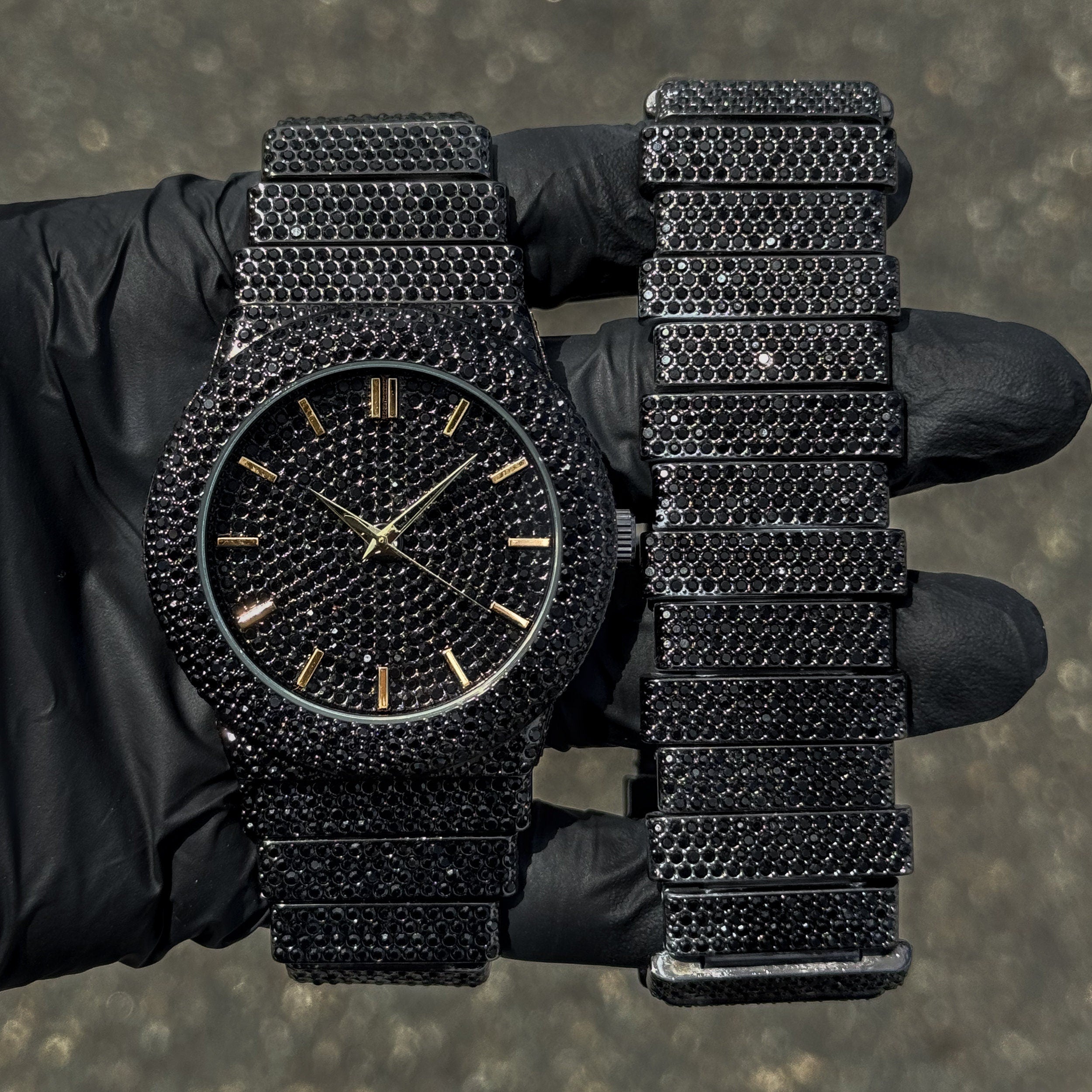 Men's 46mm black diamond watch with gold markers and matching staggered bracelet luxury set.