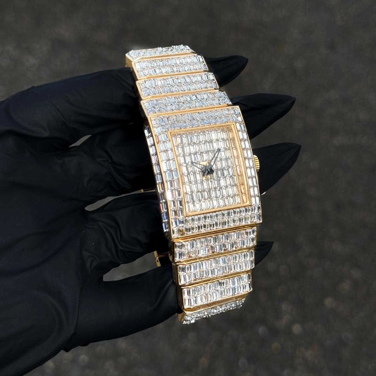 Gold Women's 30mm iced-out diamond watch featuring baguette dial and layered diamond band.