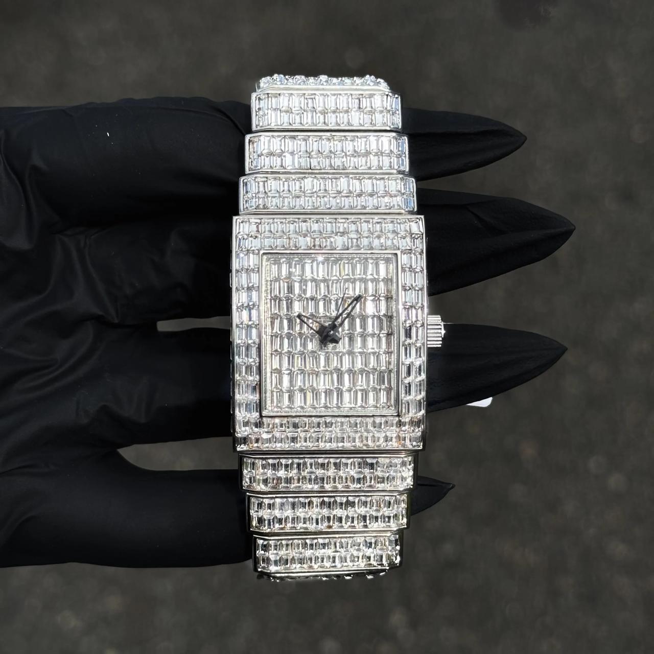 Women's 30mm silver iced-out diamond watch with square baguette dial and full diamond band.